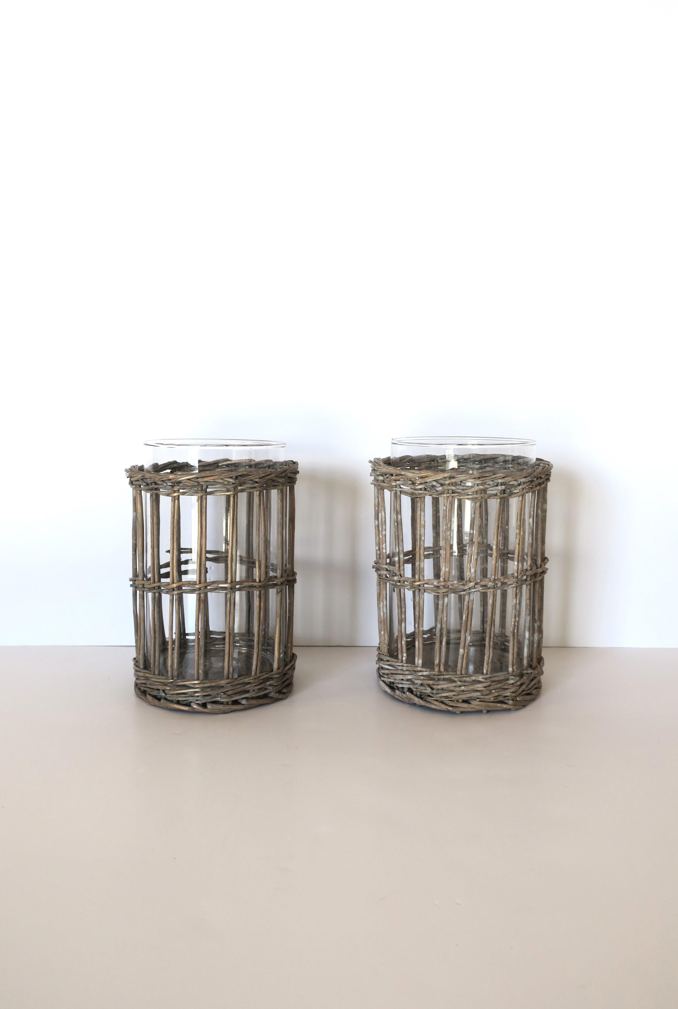 A set of two (2) wicker twig and glass hurricane candle lamps. A great set for indoors or out; dining table, steps, walkway, patio, terrace, etc. Dimensions: 6
