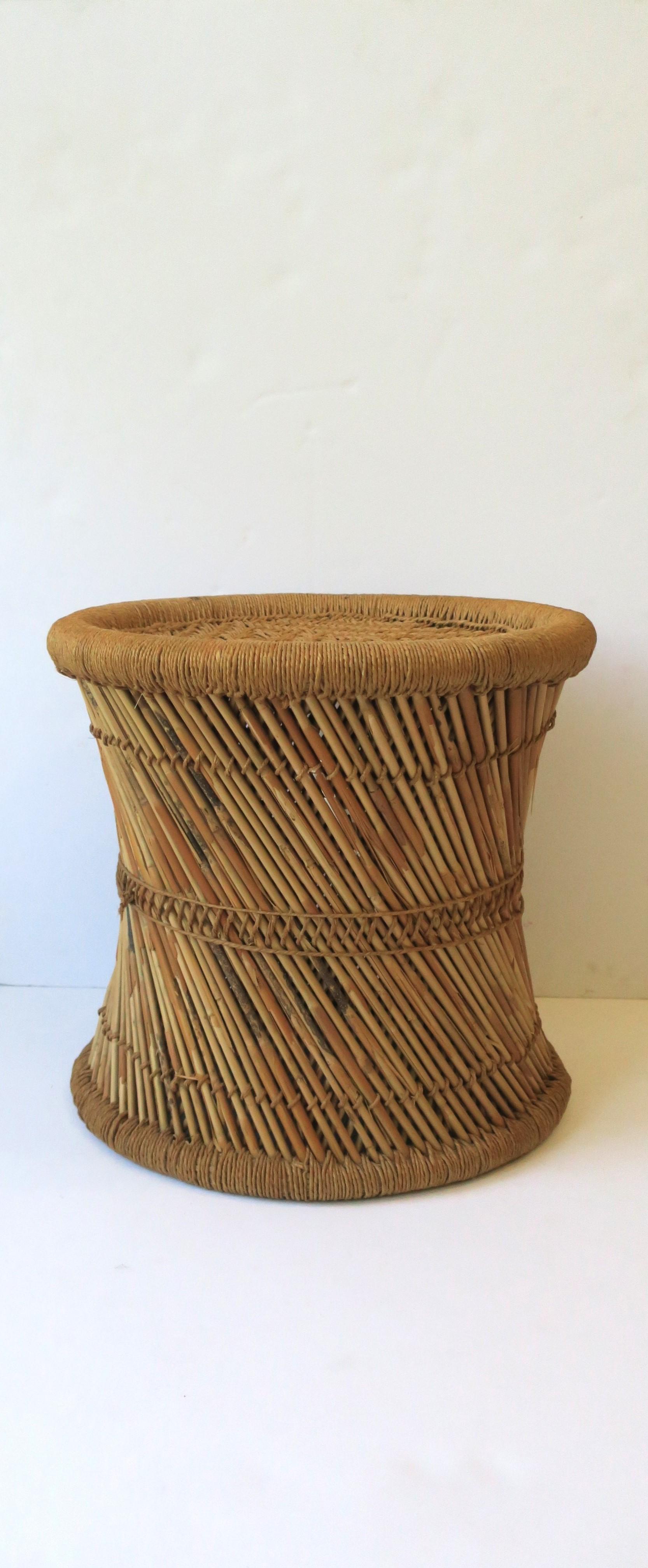 A vintage wicker pencil reed and glass top drinks side table or stool in the Anglo Raj style, circa 20th century, India. Stool is sturdy and well-made and can support a human being (as intended.) Stool can also double as side table with its