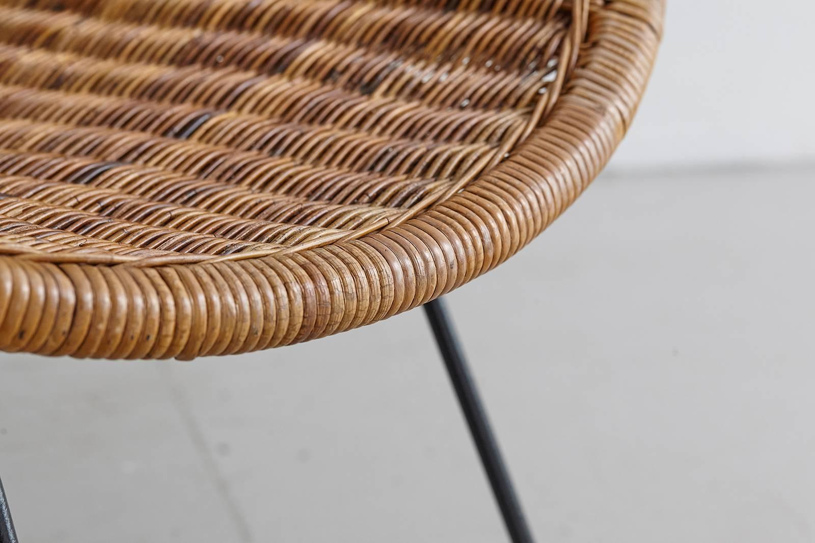 Wonderful wicker and iron bucket chair. Wicker in excellent condition. Scooped wicker seat sits on solid iron legs. Perfect for the home or covered outdoor patio.