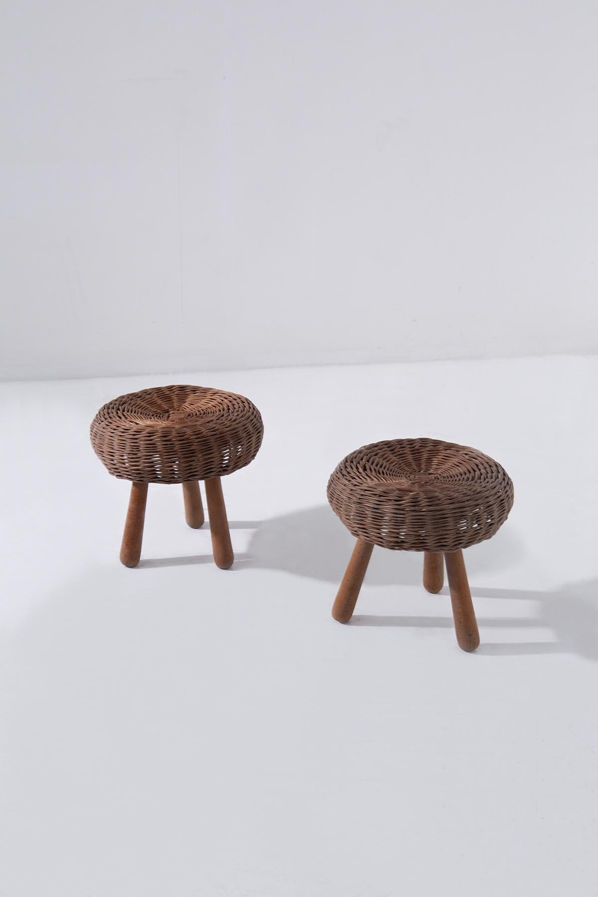 Discover timeless design and artisanal elegance with this vintage pair of stools by Tony Paul, crafted in the 1960s in the USA. These unique pieces, featuring a handwoven wicker seat supported by three sturdy wood legs, perfectly blend functionality