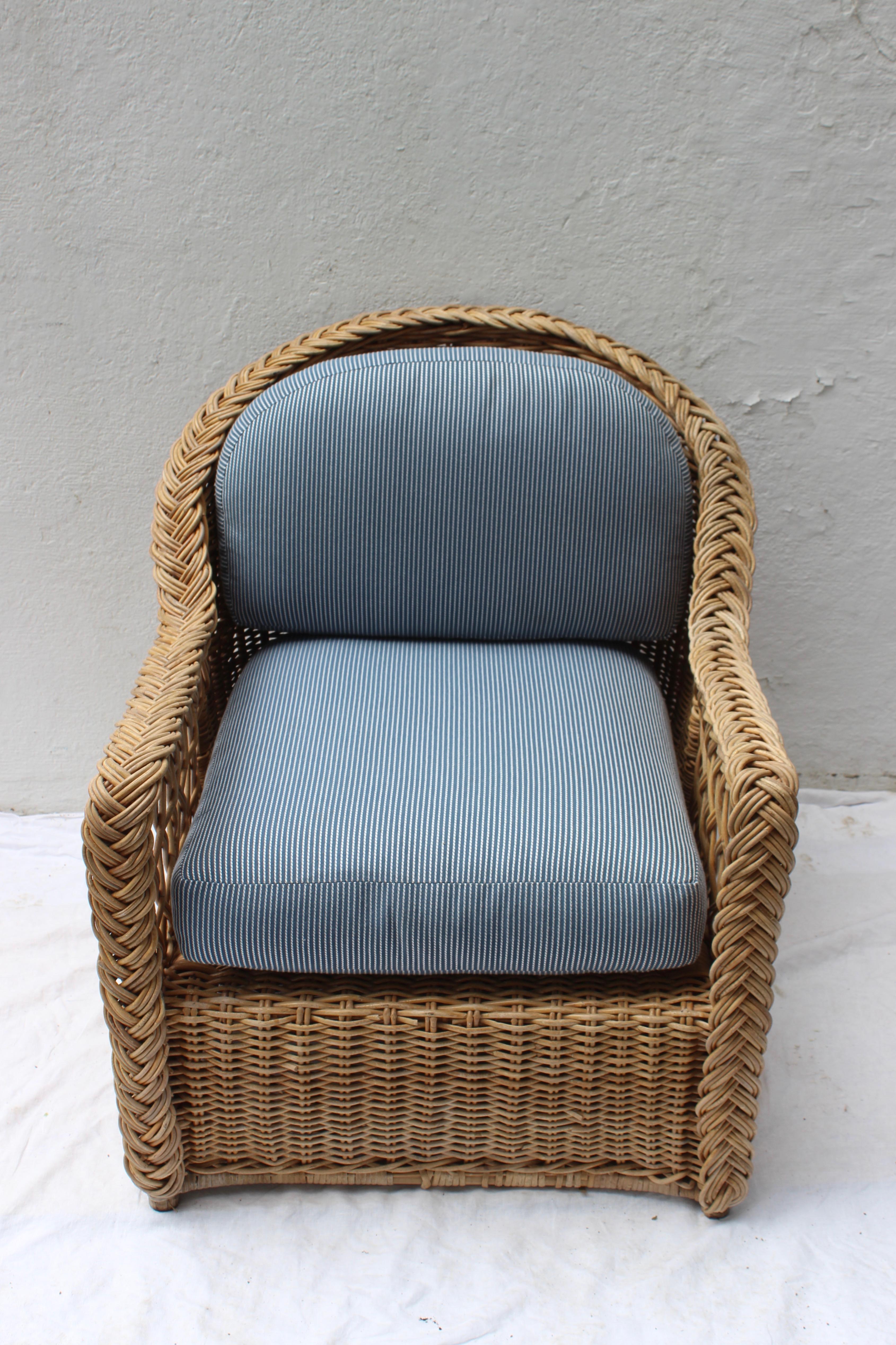 Vintage armchair with newly upholstered in blue fabric cushions.
