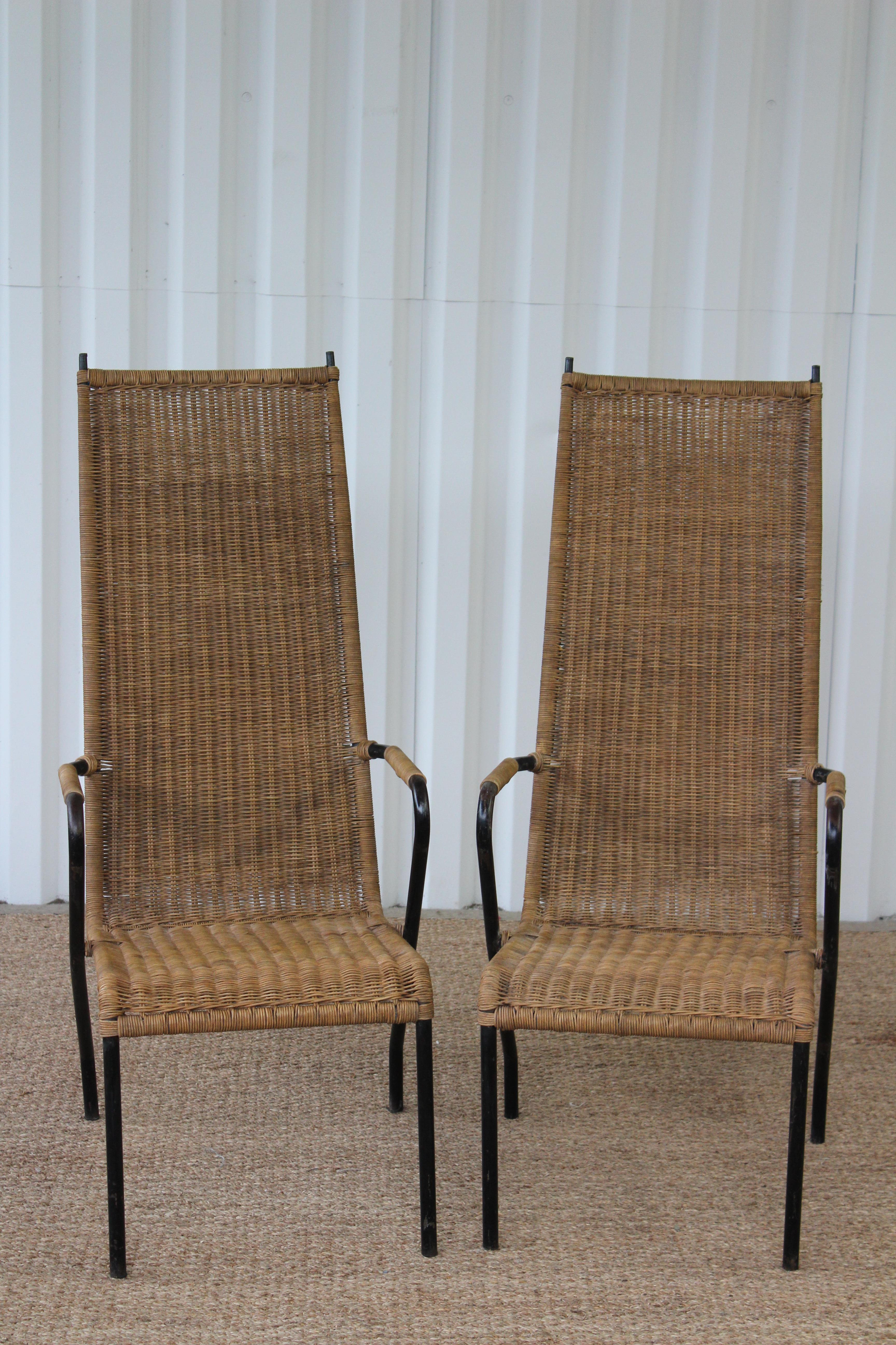 Vintage 1950s wicker and metal armchairs. Four available, each sold individually. Each chair has new woven wicker. The metal frames were left as is to show the original patina.