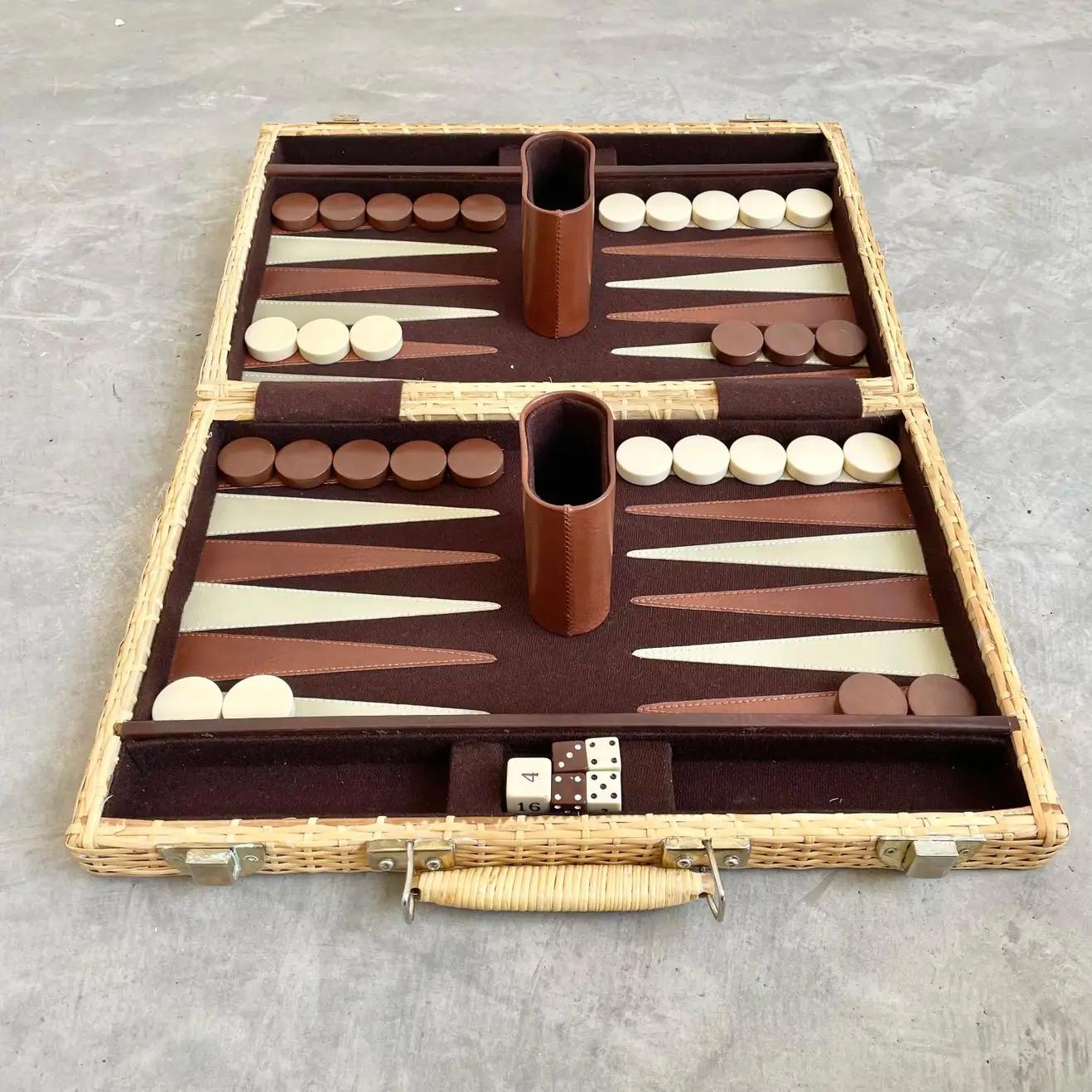 Beautiful wicker portable backgammon board. Brass hardware and wooden frame completely wrapped in wicker. Brown felt interior and brown and cream triangles for gameplay. Board includes all brown and cream chips, 2 brown and 2 white dice as well as a