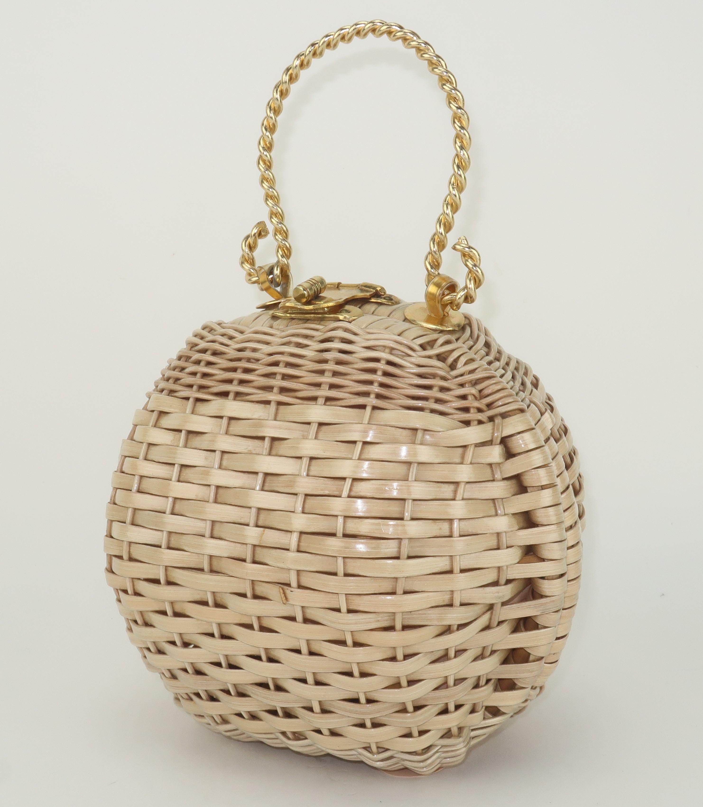 Adorable 1960's coated wicker handbag with a spherical silhouette and twisted gold metal handle.  The kisslock closure opens to reveal a vinyl lined interior.  The base is outfitted with plastic tab feet and vinyl hinges.  Perfect vintage accessory