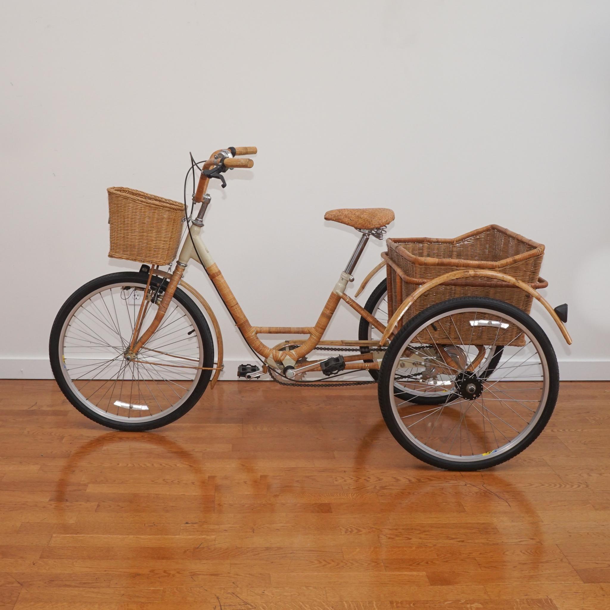This wicker and bamboo adult tricycle is sure to garner attention. Made in the 1980s, the steel frame is artfully wrapped with wicker and bamboo and comes with a small wicker basket in the front and a larger removable wicker basket in the back. Even