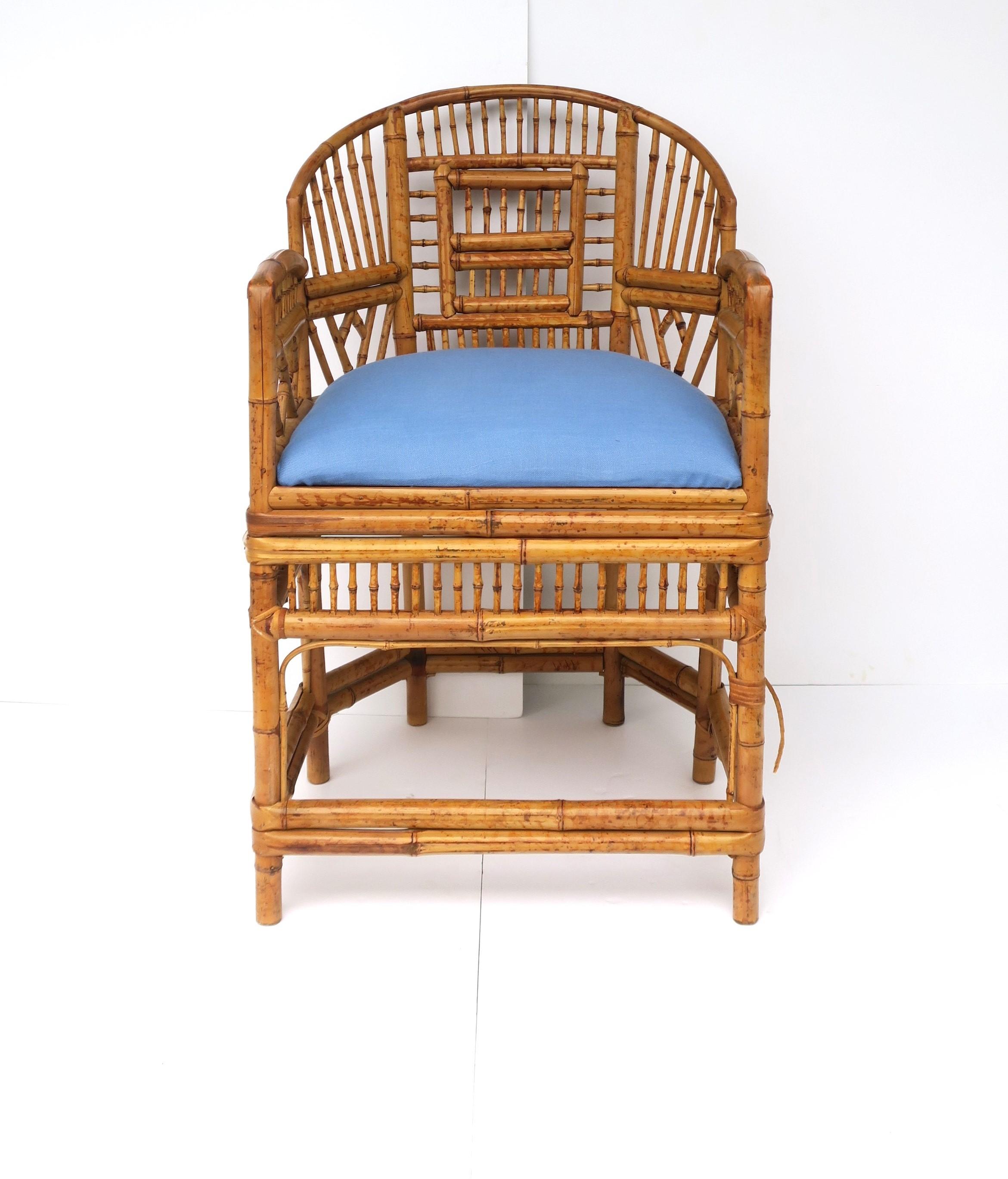 A beautiful and well-made all-bamboo armchair with 'spindle' sides and back and a light-blue upholstered seat cushion, in the Chinoiserie design style, circa mid-20th century. A great piece to add to many interior environments including a living