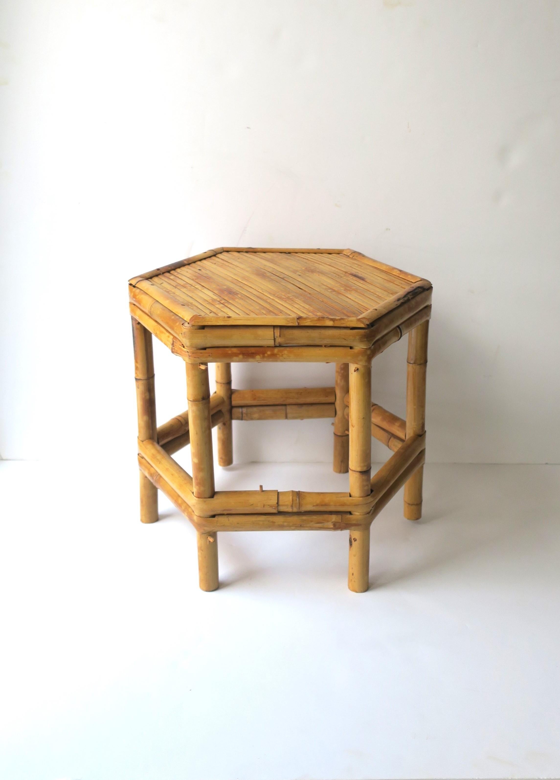 A small, low, wicker bamboo pedestal table or plant stand, etc., circa 1970s, Asia. Piece has a 'hexagon' shape, which is a nice alternative to round or square. A great piece to hold a drink, books, plant, etc. Piece is a convenient