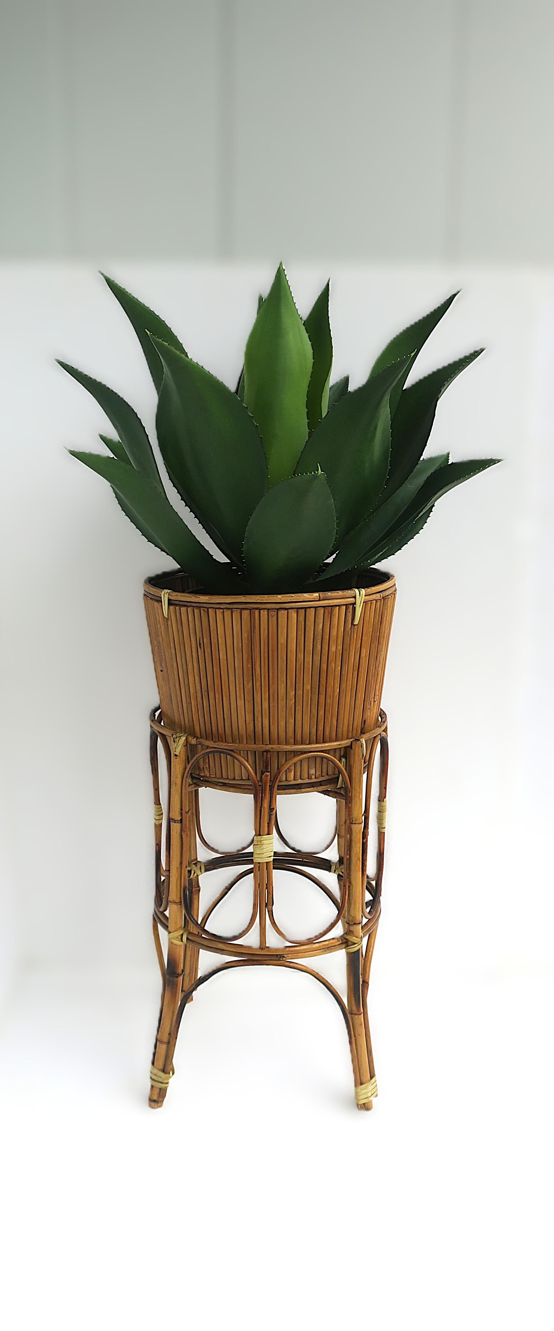 A wicker bamboo plant stand holder cachepot. Piece has a wicker bamboo base with a bamboo plant pot holder cachepot. 