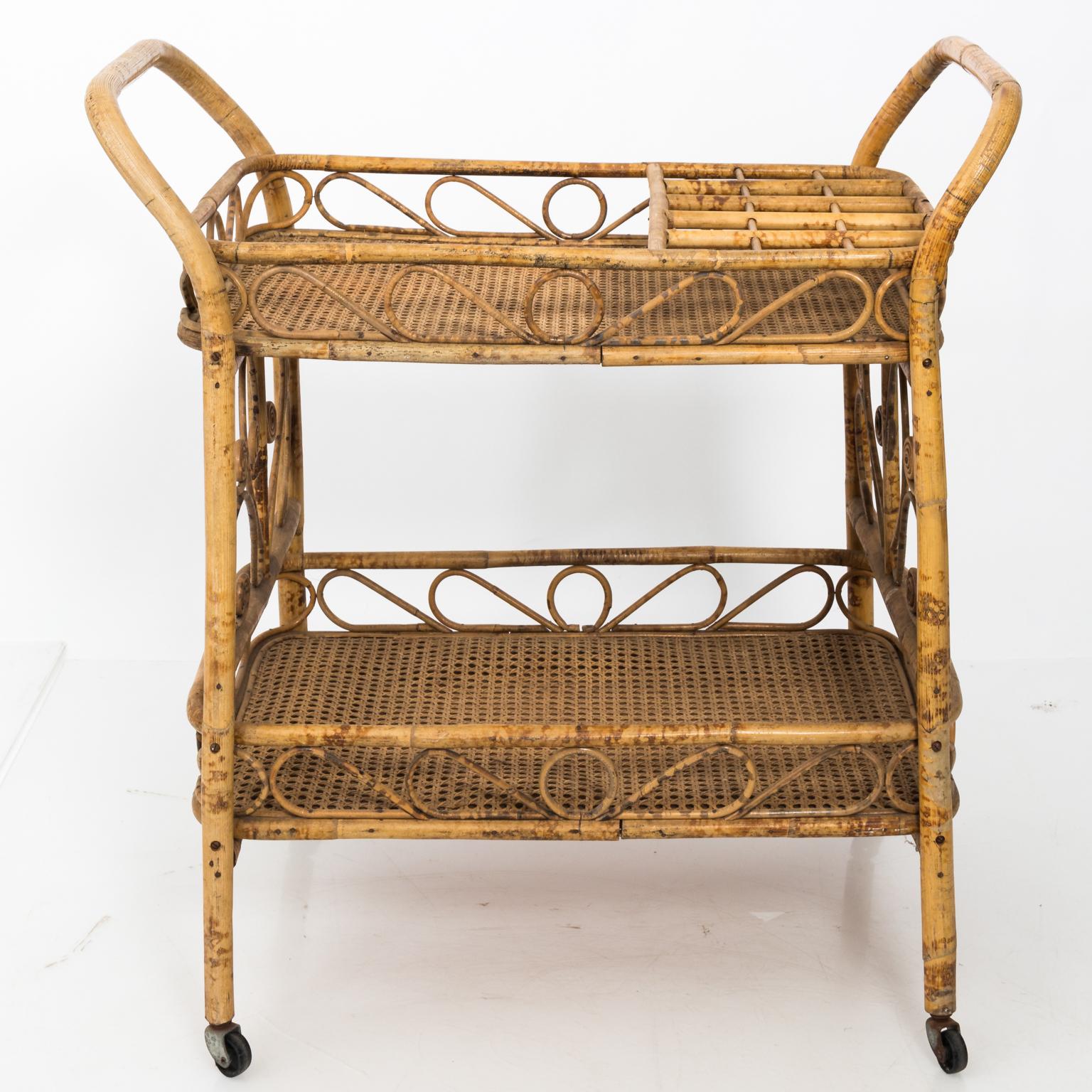 Vintage wicker bat car on wheels with cane woven tabletop and bamboo frame, circa mid-20th century. Please note of wear consistent with age.
  
