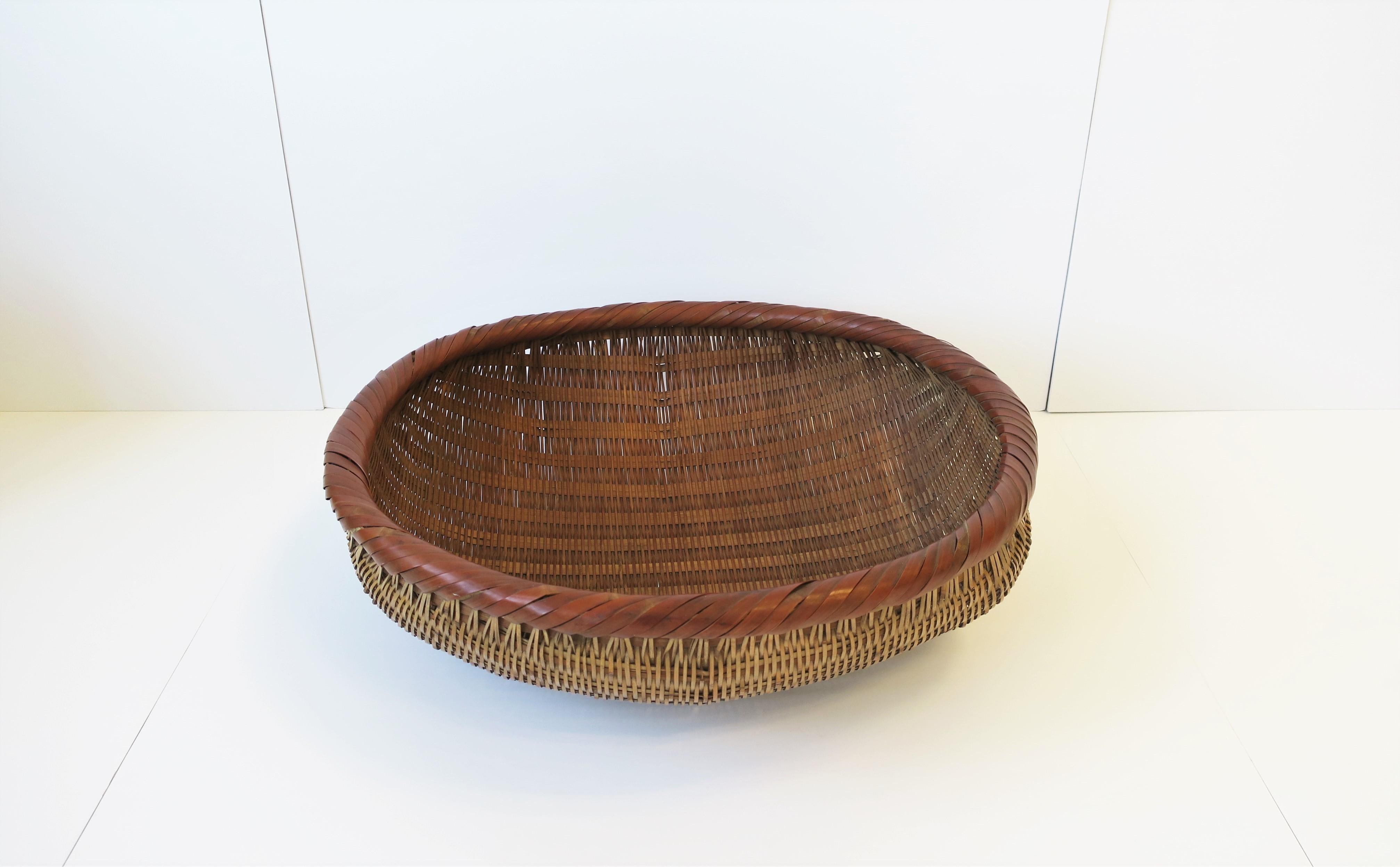 A beautiful vintage large 'field gathering' garden wicker basket with decorative wrapped edge. Piece could also make a great centerpiece on a table considering its size. Bottle shown in images #5 and 11 for perspective. Dimensions: 6.5