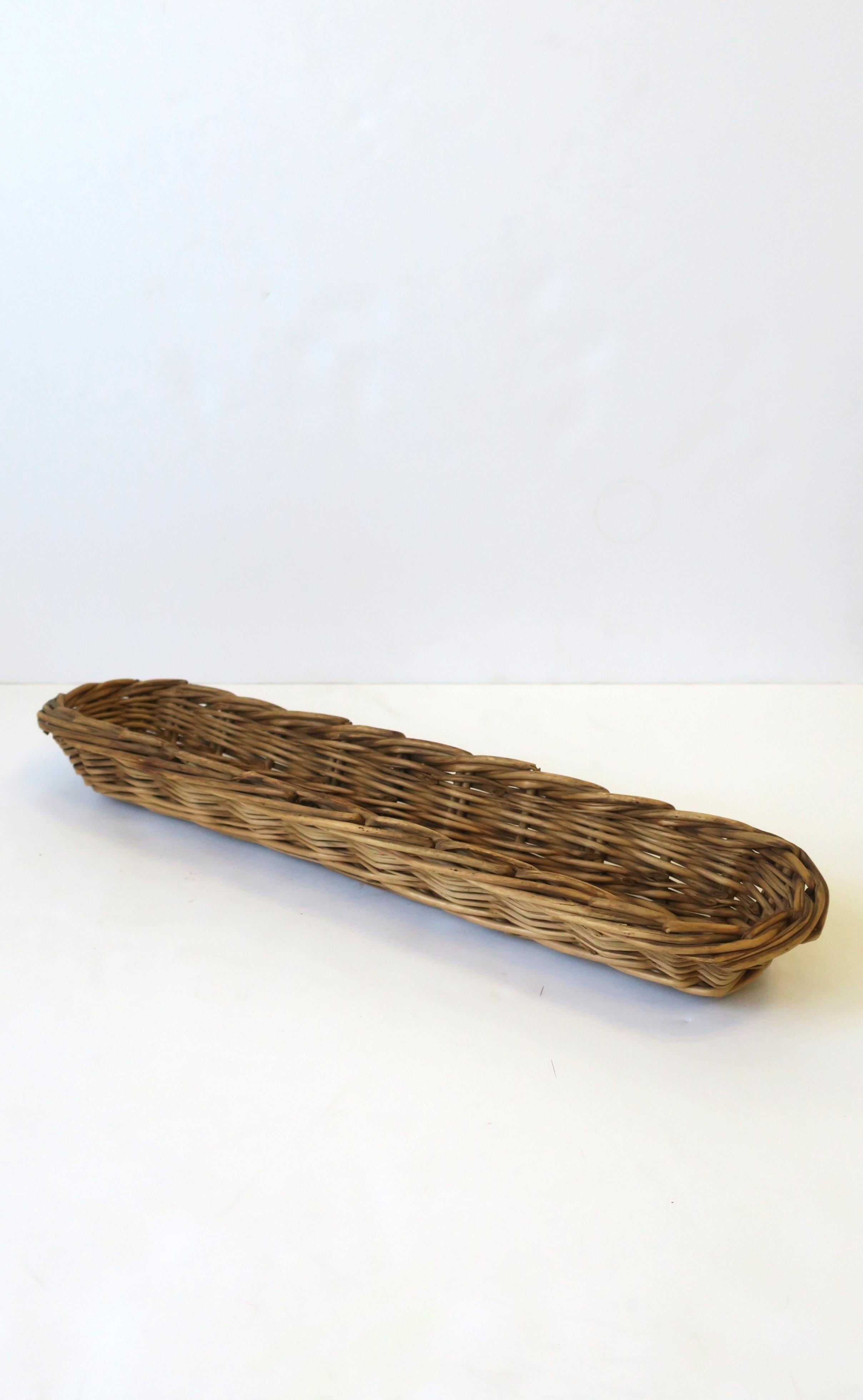 A vintage wicker basket, circa mid-20th century, USA. A great decorative basket for fruit, vegetables, bread, etc. Piece is oblong. Dimensions: 3