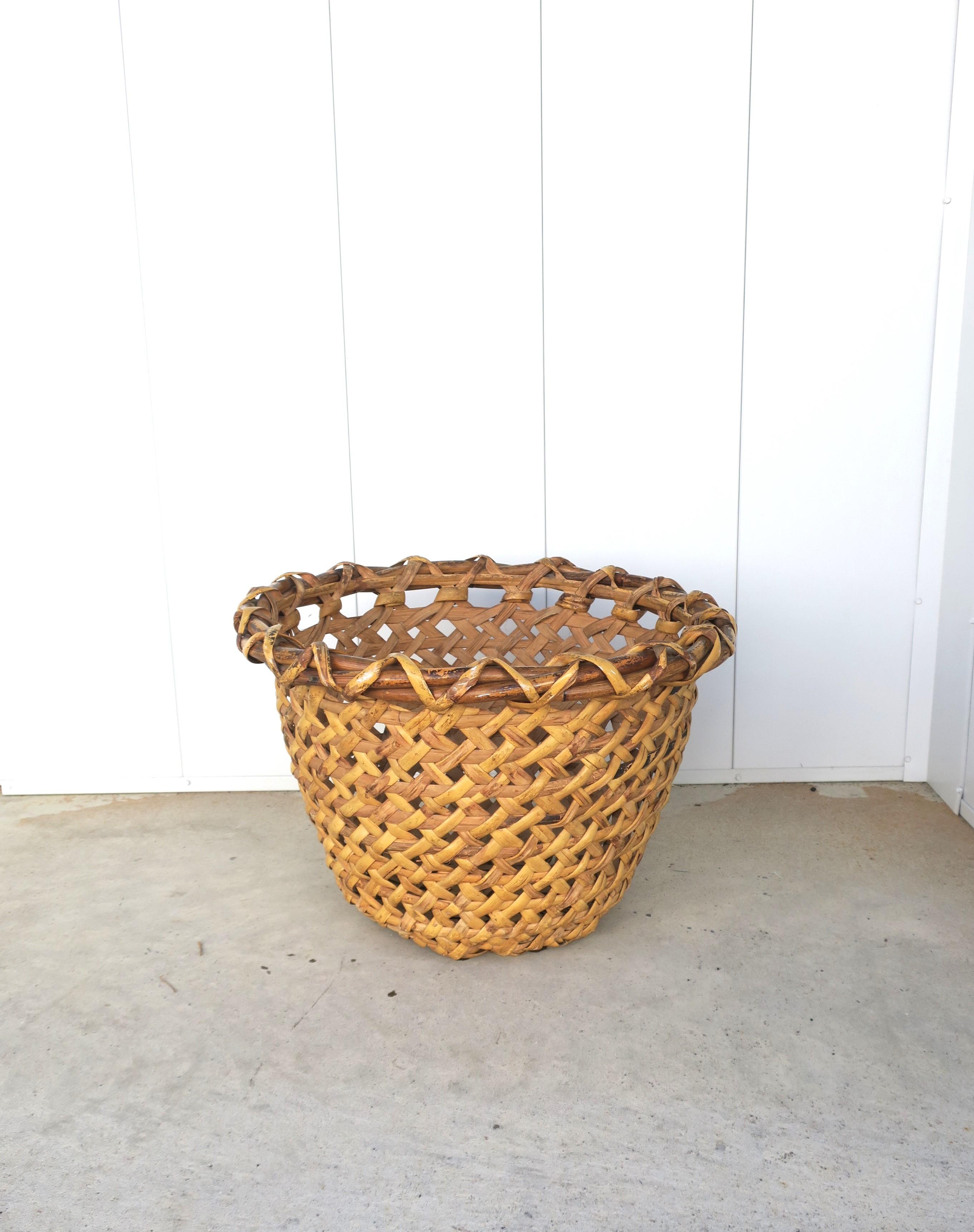 A sturdy hand-woven vintage wicker basket, circa 20th century.

Basket could be decorative, used as a planter cachepot (plant potholder), or as a laundry basket hamper/storage piece, hold clean rolled towels for a shower, bath, pool, etc., many