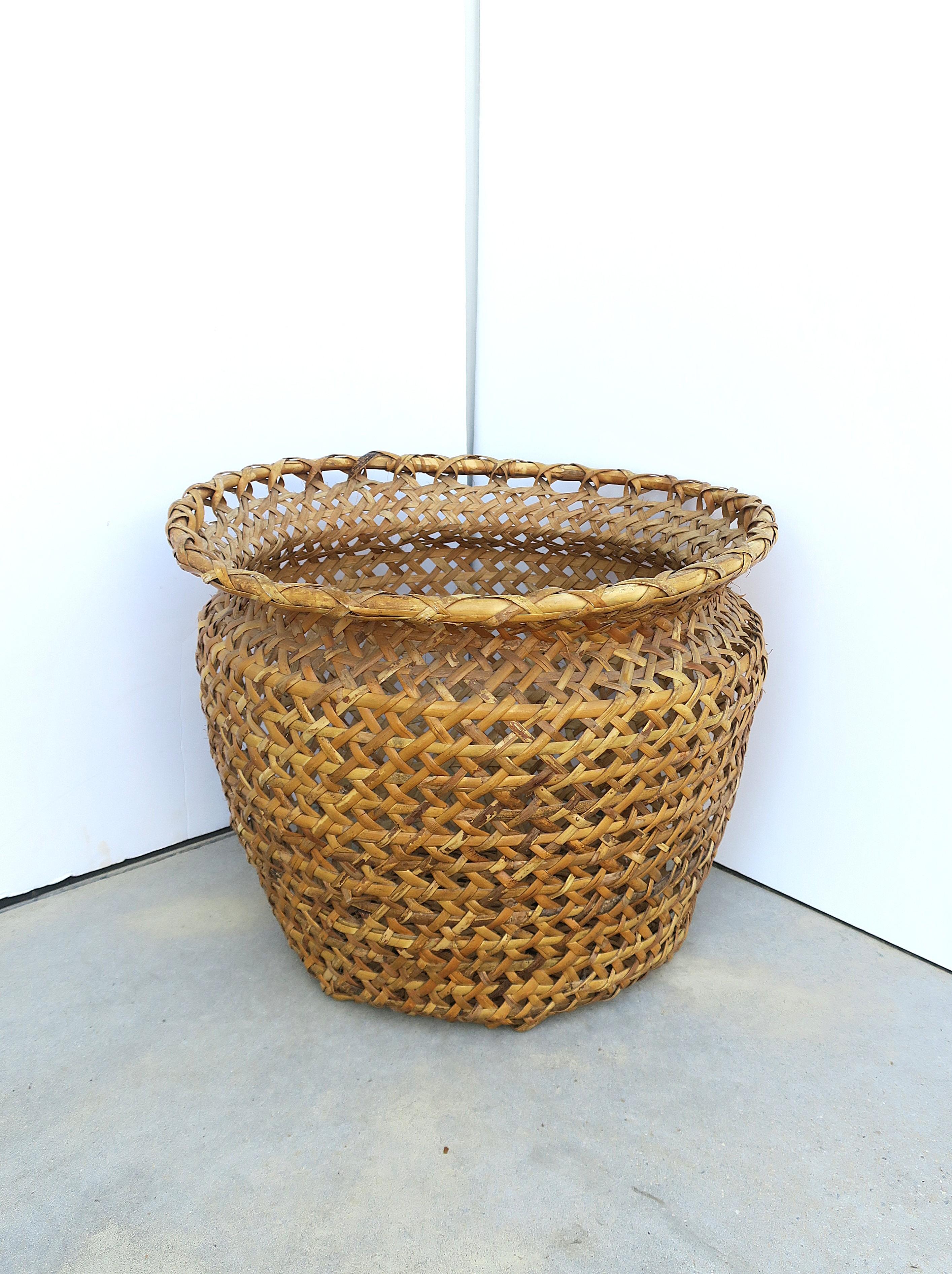Two (2) available, each sold separately. 

A hand-crafted wicker basket cachepot (plant potholder), circa late-20th century. Use to hold a plant or other item(s). Internal dimensions include 16.5