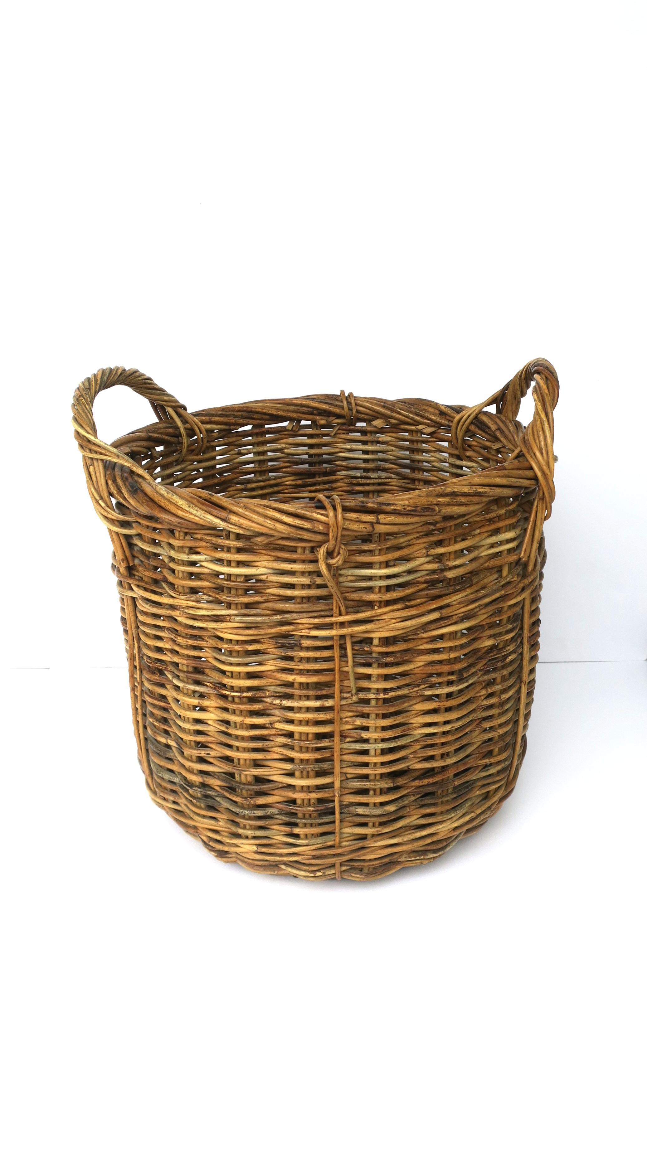 A well-made wicker basket with handles, circa mid to late-20th century. This wicker basket can be used as a plant potholder cachepot (as demonstrated), as a decorative piece, or to hold or store items, etc. Many uses. 

Overall dimensions: 17