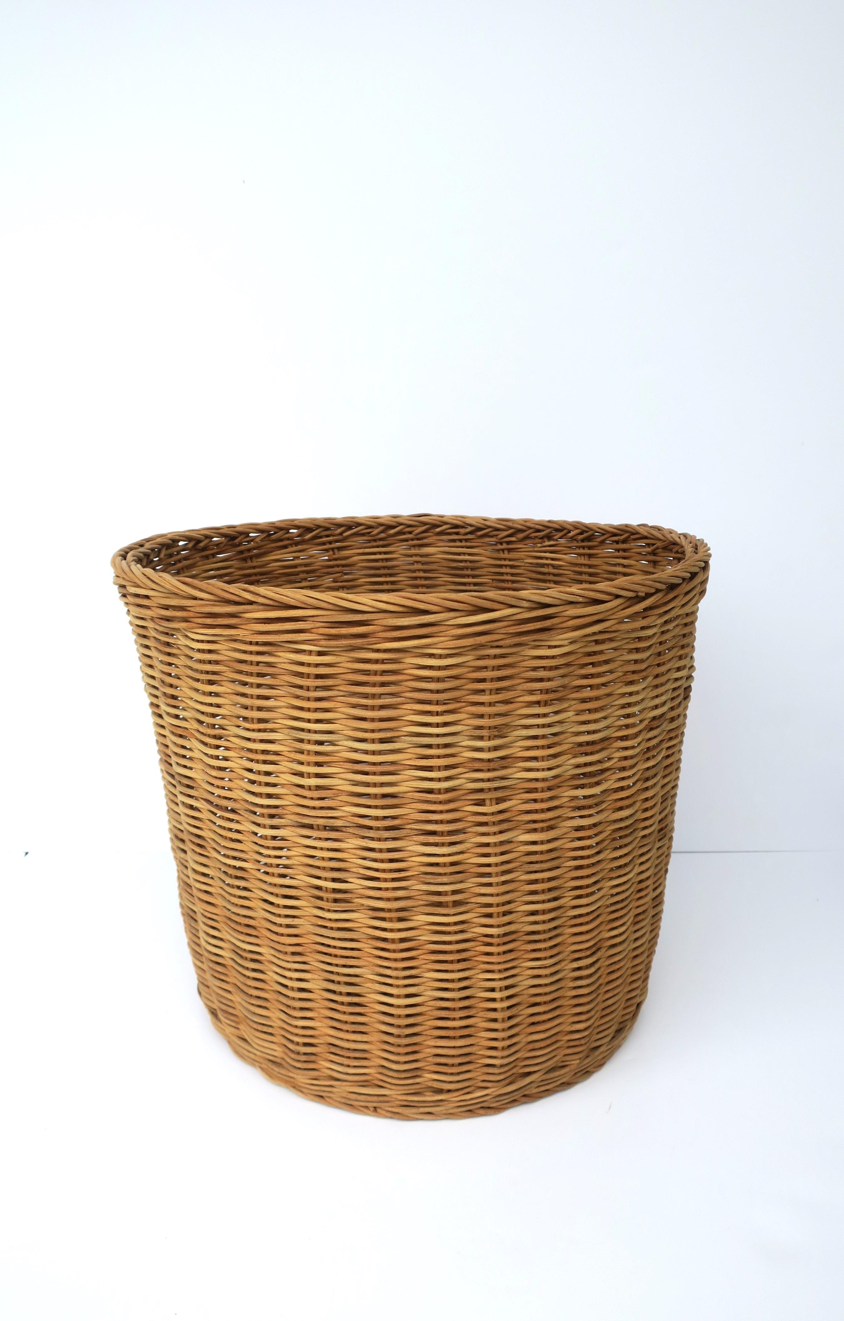 A simple wicker basket, circa late-20th century. Use as a waste basket/trash can or plant potholder cachepot (as demonstrated), etc. 

Dimensions: 15.38
