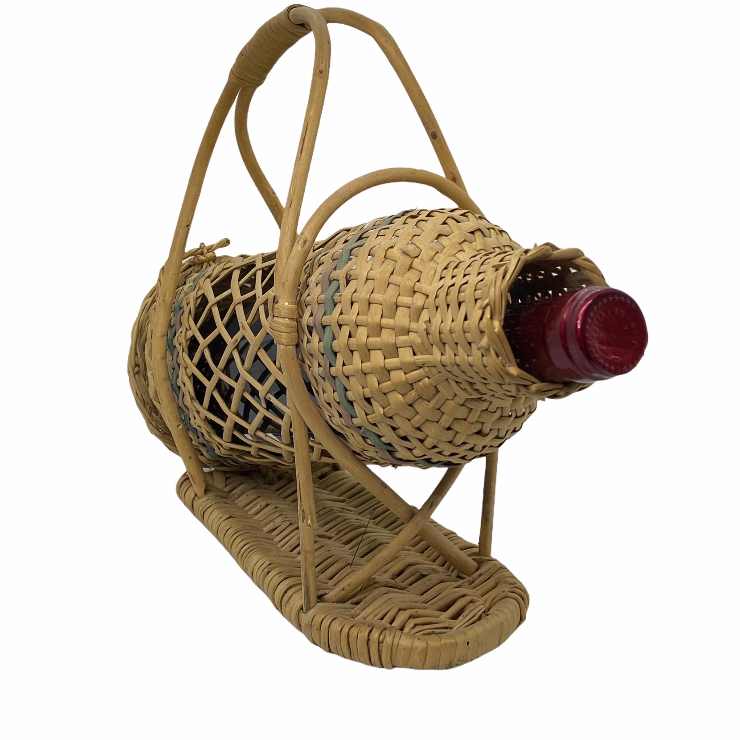 A Mid-Century Modern barware wicker basket bottle holder, Germany, 1960s. An all original midcentury item to display in your bar or just on a cupboard with a bottle of wine. Bottle not included in this offer.