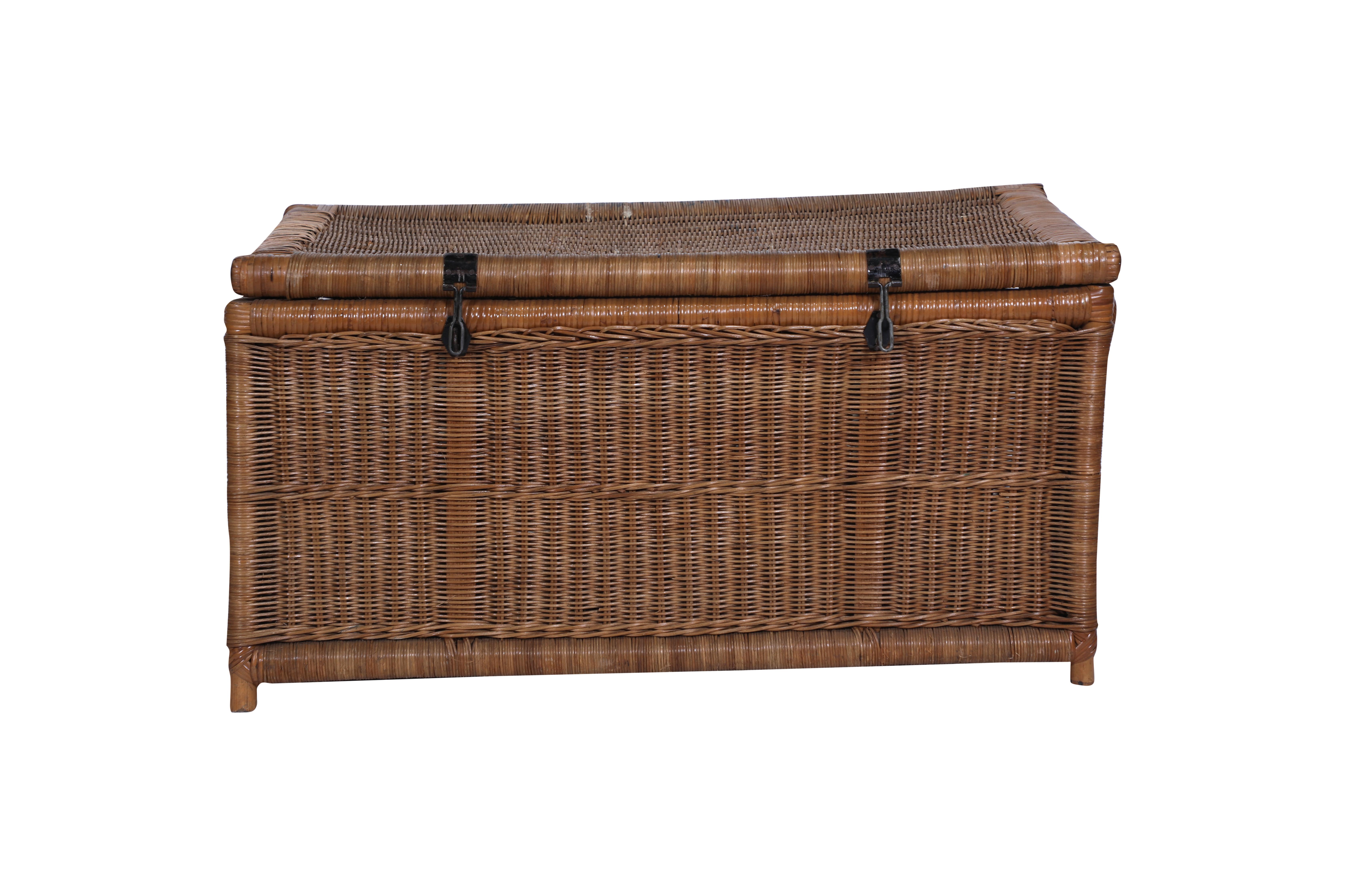 A hand-woven caned wicker blanket chest or trunk with iron handles and hasp locks.  In very good condition with some blurred writing along the top edge.  Great as a coffee table or blanket storage.  Colonial British.

The Lockhart Collection is a