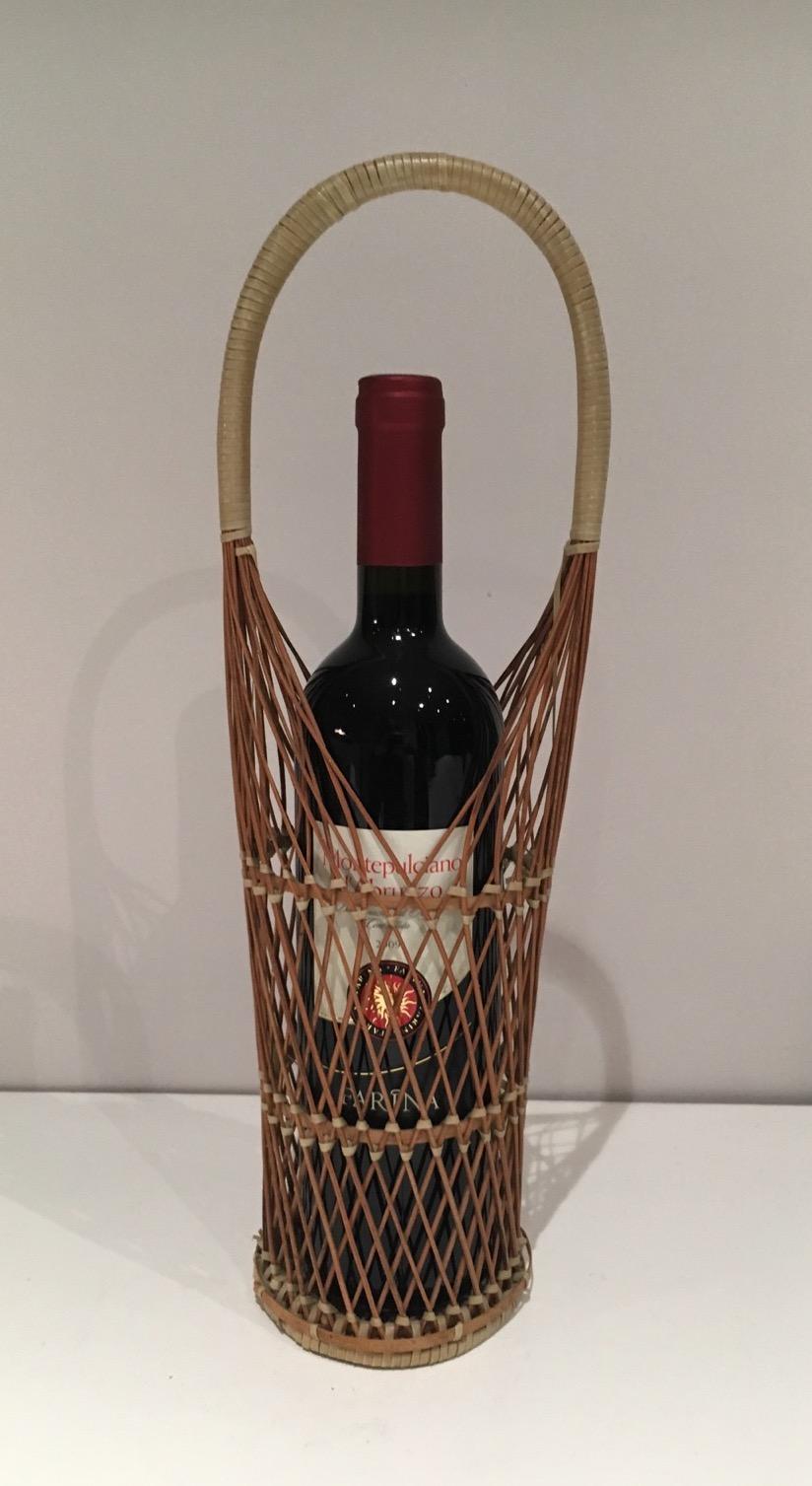 This bottles holder is made of wicker. This is a French work. Circa 1970.