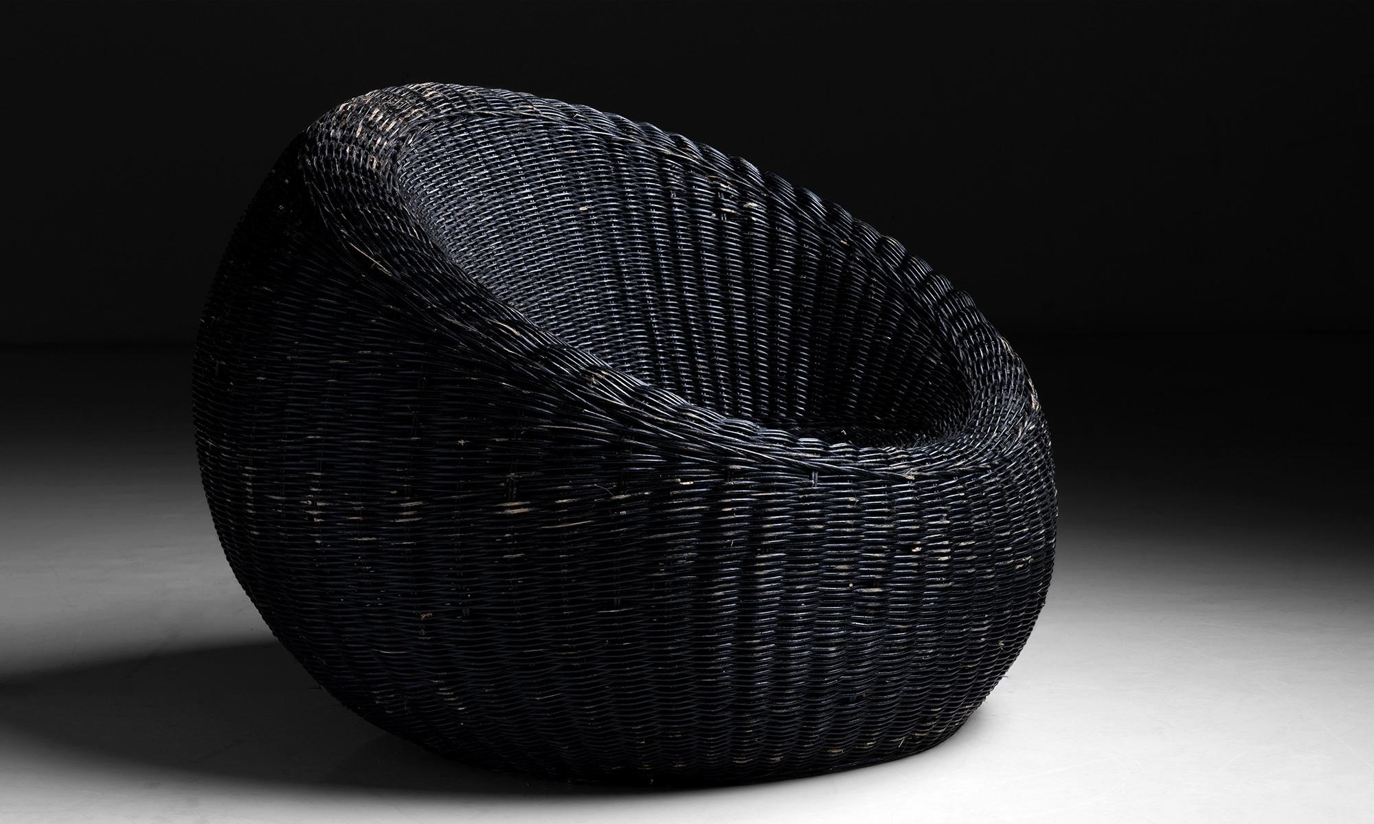 Wicker bucket chair.

England, circa 1950.

Unique chair with original black paint.

Measures: 36”diameter x 28”height x 13”seat.