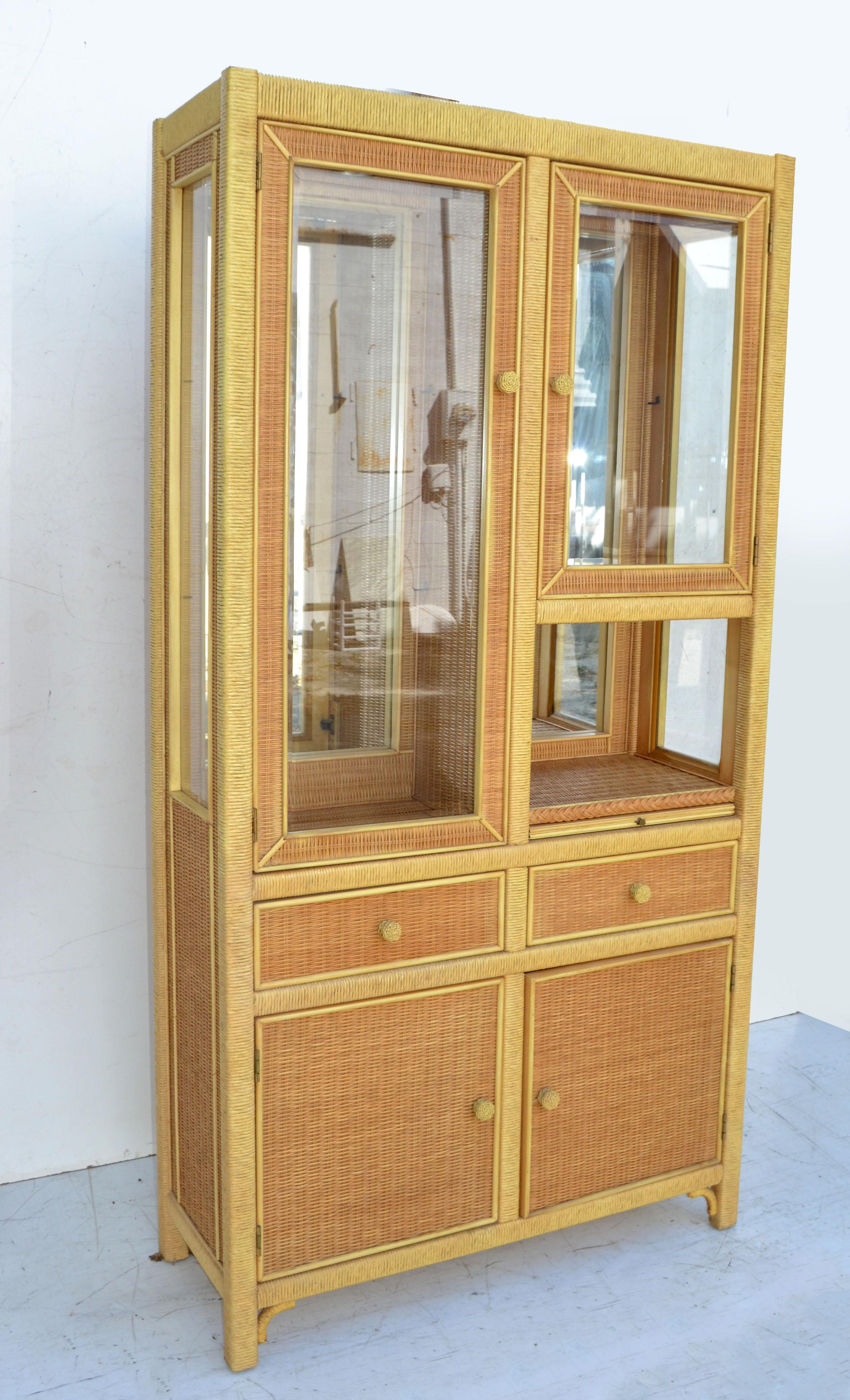 American Mid-Century Modern Wicker by Henry Link handcrafted China Cabinet or Cupboard made out of Bentwood Wicker, hand woven cane, 4 Glass shelves and mirror Back wall. 
Featuring at the Base 2 doors with 2 shelves, 2 drawers, one with Silverware
