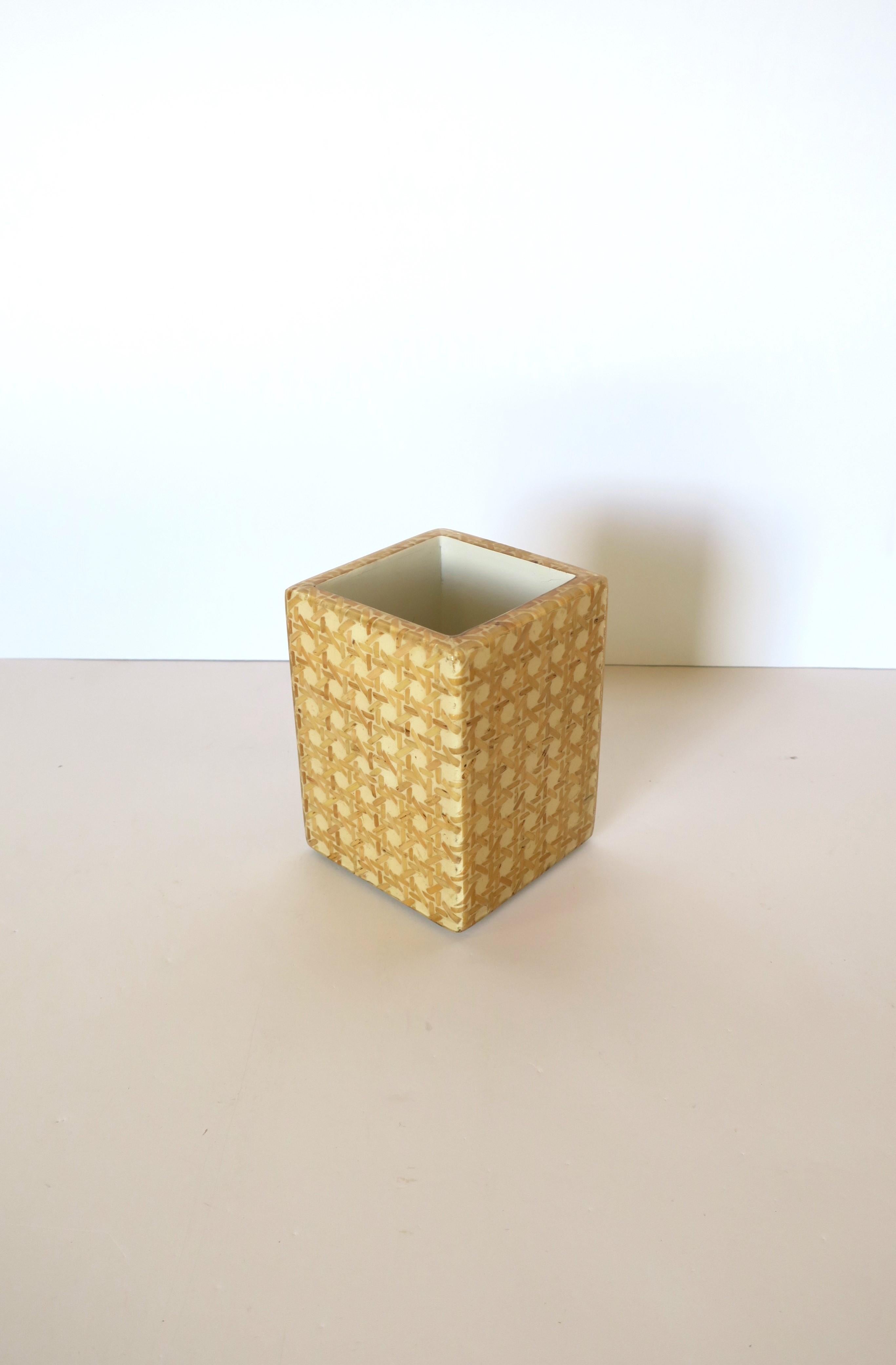 A wicker cane acrylic bathroom vanity toothbrush or pen/pencil desk accessory holder. Piece is blonde cane wicker covered in clear acrylic. Piece appears to have never been used. A great piece for bathroom vanity area or desk (demonstrated holding