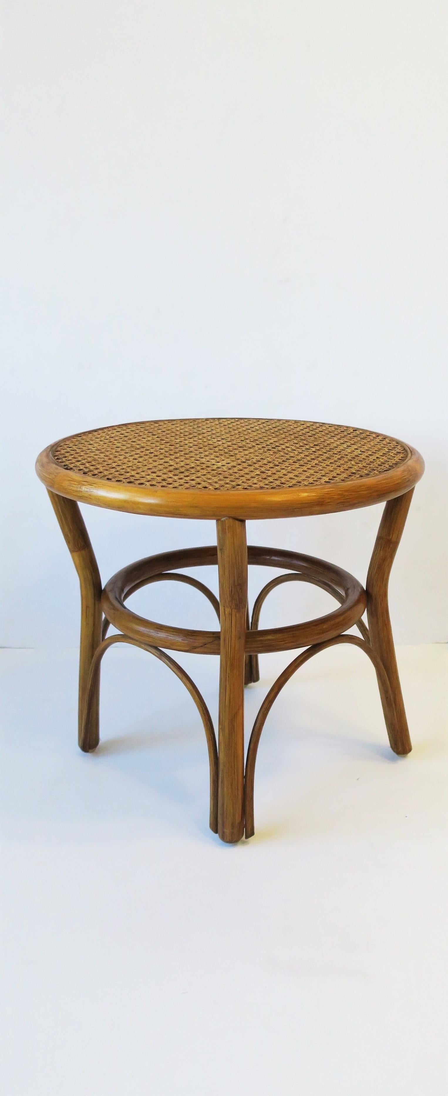 A vintage round wicker cane top and rattan side or end table, circa late-20th century. 
Dimensions: 17.75