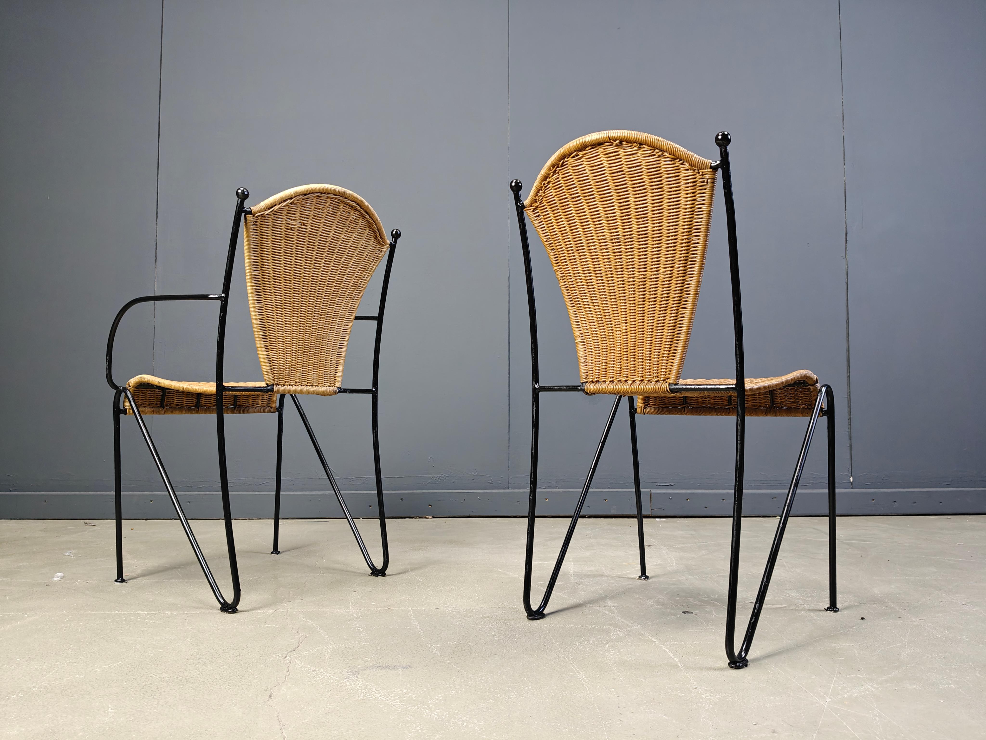 Vintage wrought iron and wicker bistro/dining chairs designed by Frederick Weinberg.

Elegant black wrought frame with a curvy wicker seat.

Very sturdy chairs good for in home and outside use.

Two chairs have armrests.

1960s - France

Good