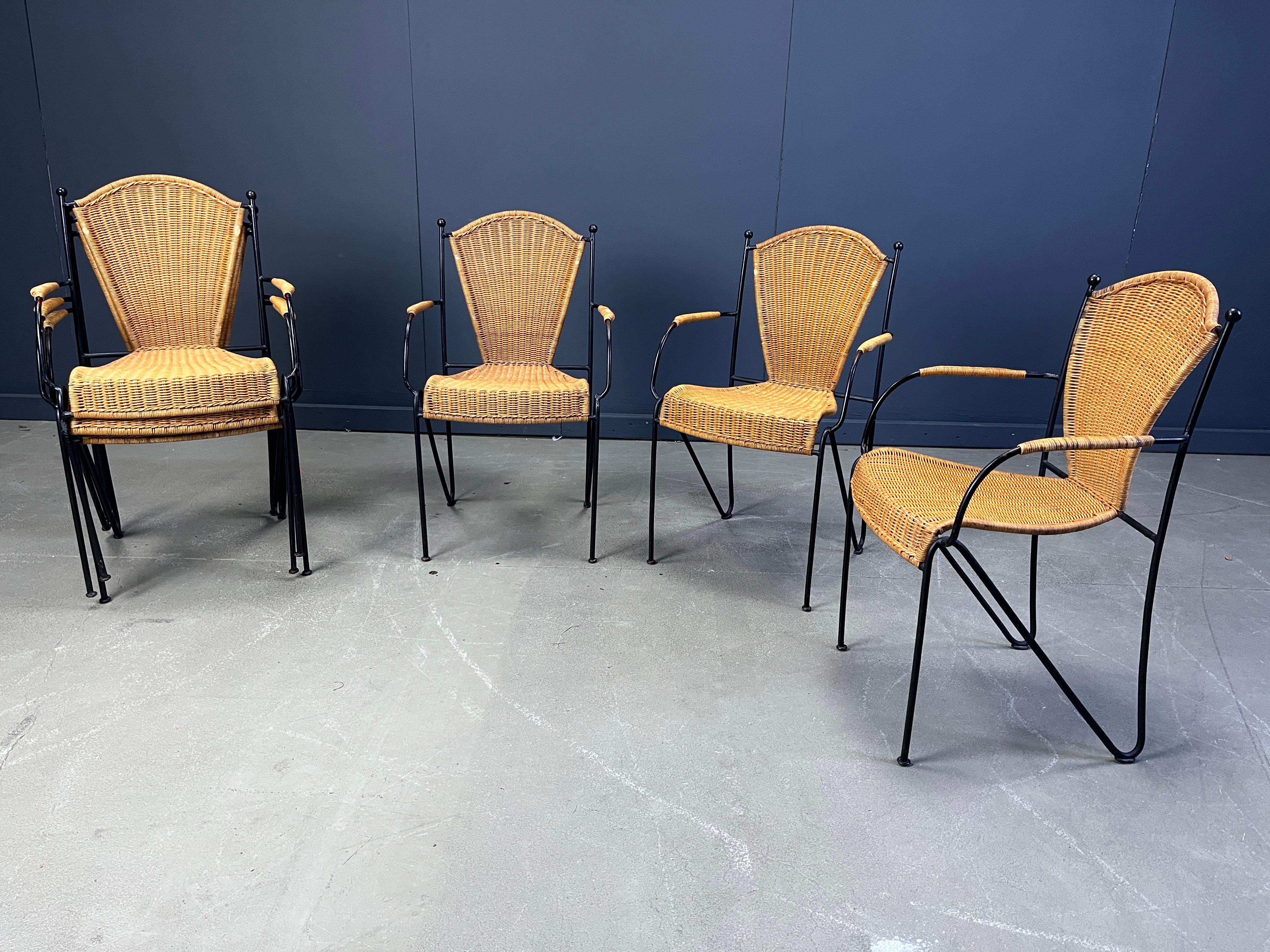 Vintage wrought iron and wicker bistro/dining chairs designed by Frederick Weinberg.

Elegant black wrought frame with a curvy wicker seat.

Very sturdy chairs good for in home and outside use.

Two chairs have armrests.

1960s - France

Good