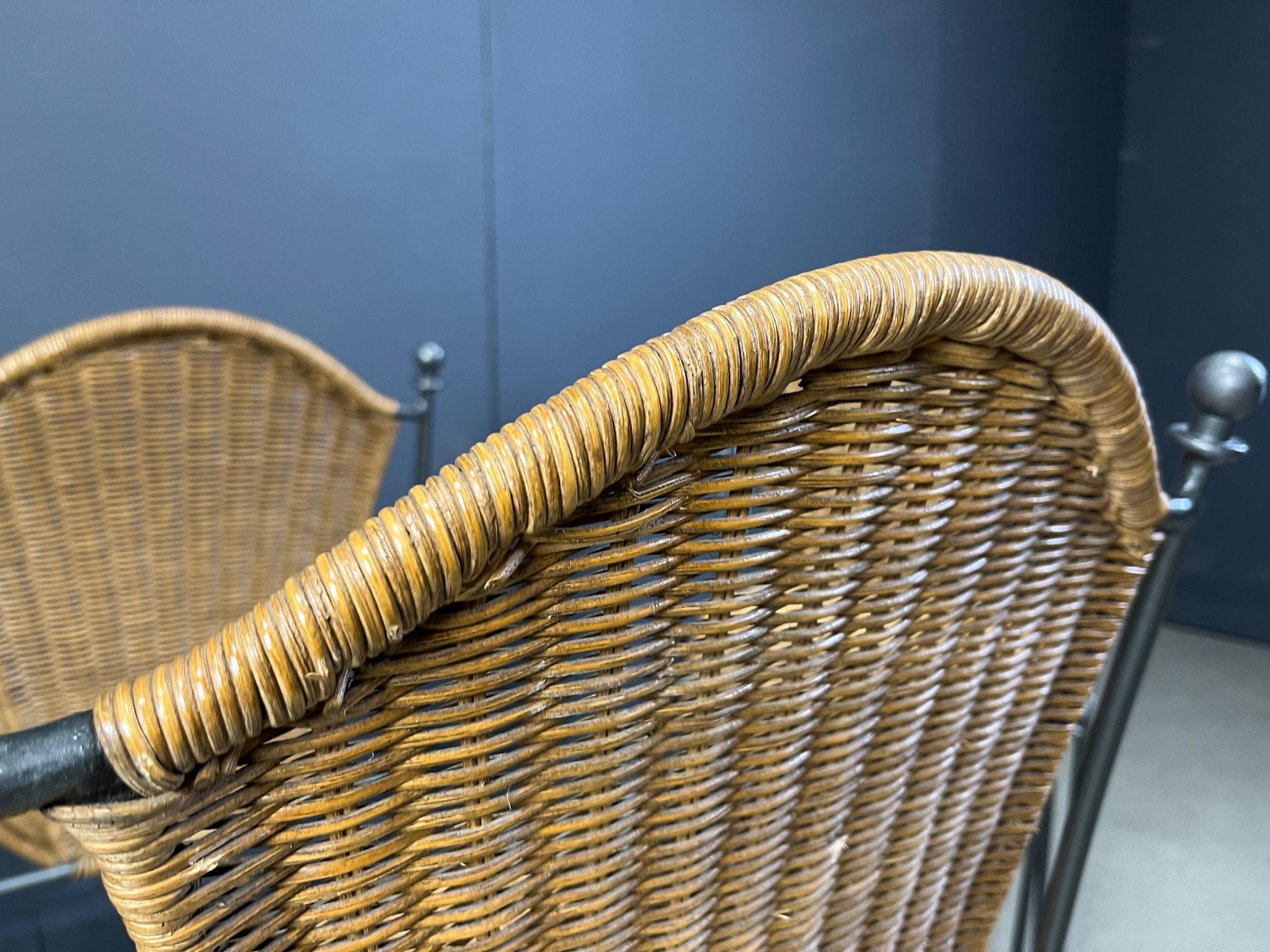 Vintage wrought iron and wicker bistro/dining chairs designed by Frederick Weinberg.

Elegant black wrought frame with a curvy wicker seat.

Very sturdy chairs good for in home and outside use.

1960s - France

Good condition

Dimensions:
Height: