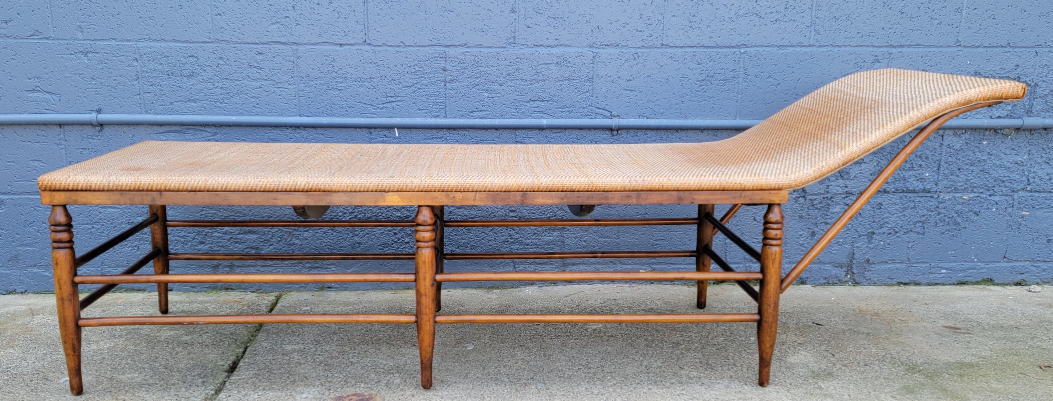 Unusual hand made chaise lounge made of turned wood and wicker. Circa. 1900. Beautiful glow to finish. Wicker upholstery would fit well in a rustic or organic decor. Frame has older restoration. Wicker has fading. This piece appears to be more