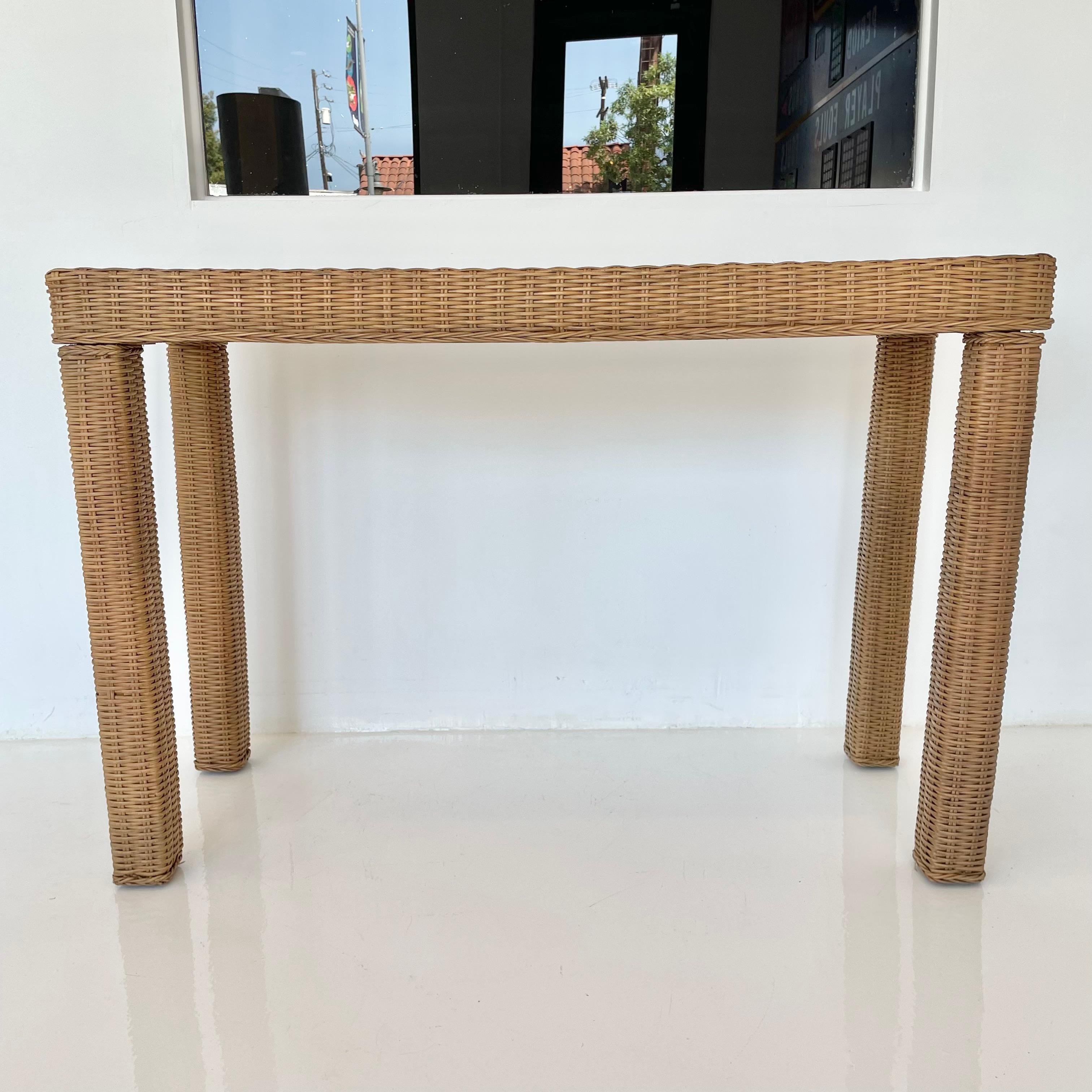 Wicker console table with solid wood frame. Good vintage condition. Perfect entry way console. Also the perfect size/shape for behind the sofa. Classic lines and design.


