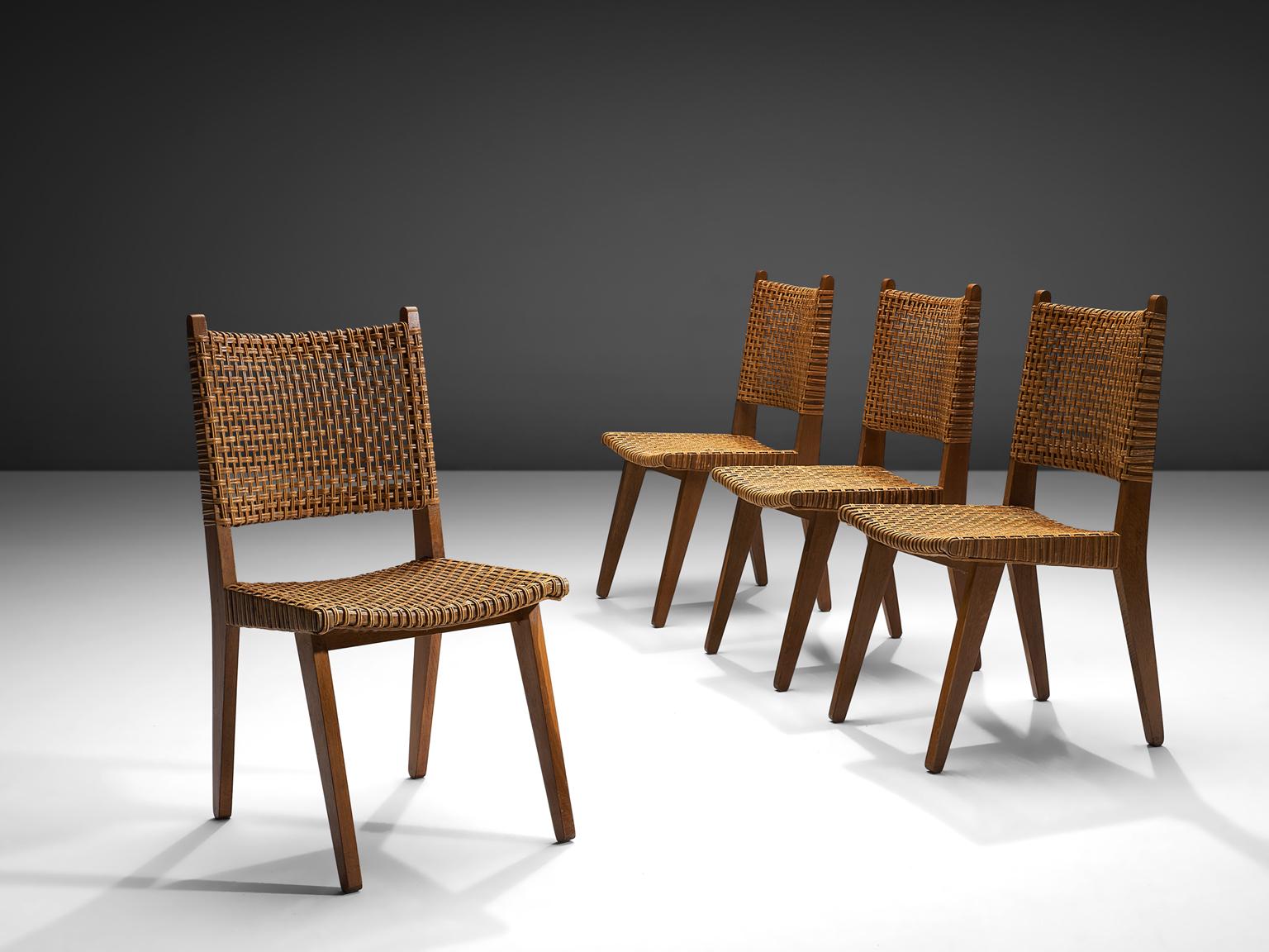 Dining chairs in cord and oak, the Netherlands, 1950s. 

This set of chairs is executed in the style of Pierre Jeanneret. The set of four chairs is sensuous, sculptural and elegant. The chairs feature high backs. The straight, tapered legs are
