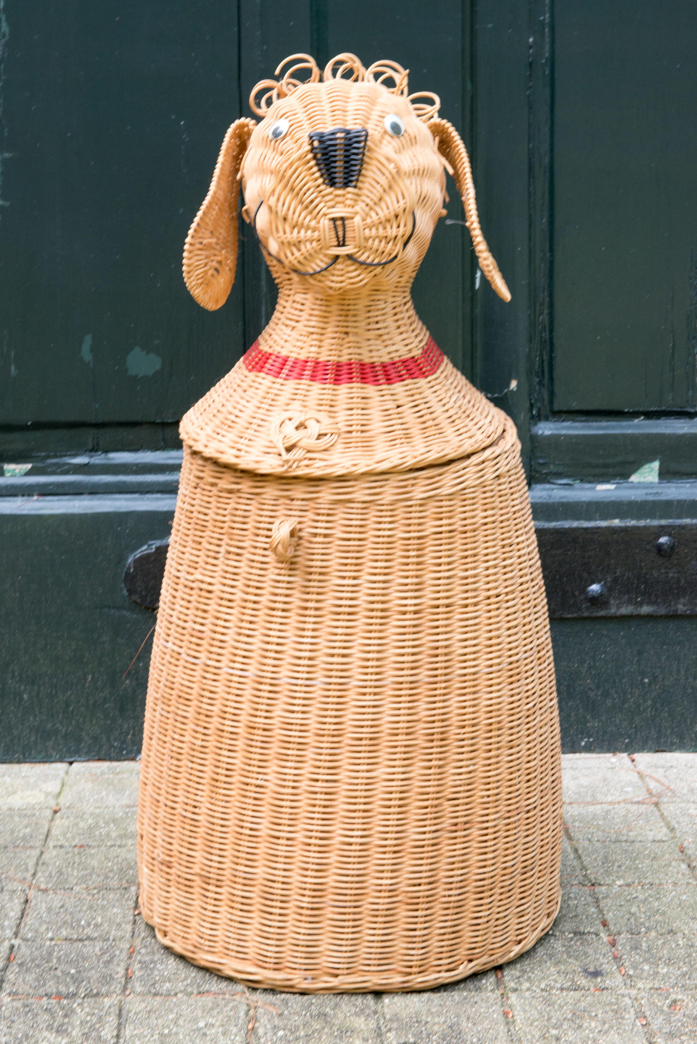 This is a very rare dog shaped covered basket. The basket lid is a very animated and charming dog head with long ears, expressive eyes, wicker curls on the top of his head, and a big black nose. A unique object.
 