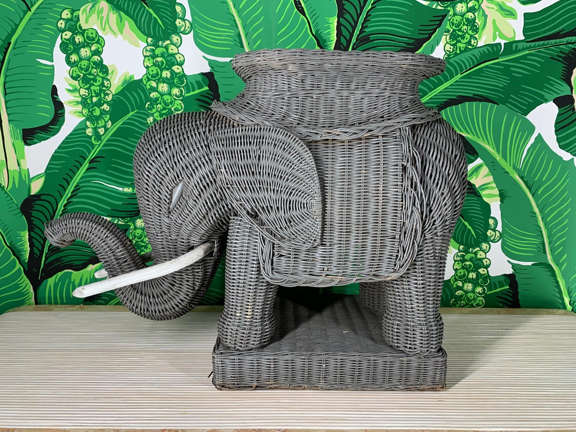 Vintage 1960s-1970s woven wicker elephant garden stool/side table in excellent condition. Rigid wood frame construction with densely woven sculpted wicker. Wooden tusks and plinth style base. Very good condition.