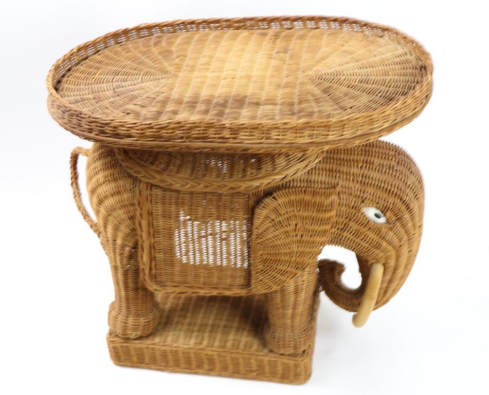 Chic and fun wicker wicker in the form of an elephant, having its original removable tray top surface. This example shows minor wear, loss to bits of wicker weaving, discoloration ( Top surface of tray ) etc. Overall good condition, showing only
