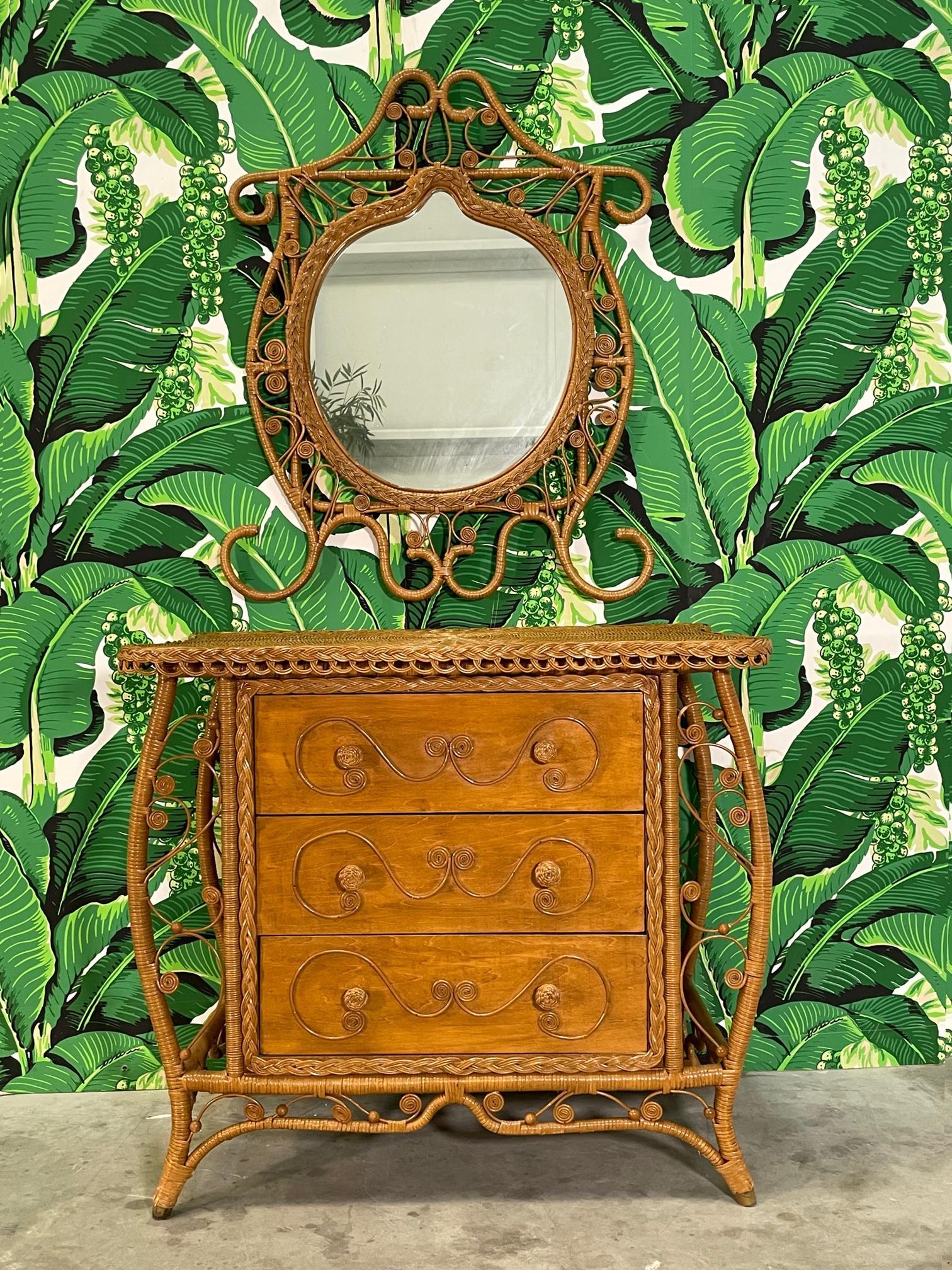 Vintage triple dresser features wicker veneer and detailing in the Fiddlehead style. Matching mirror included. Dresser measures 39.5