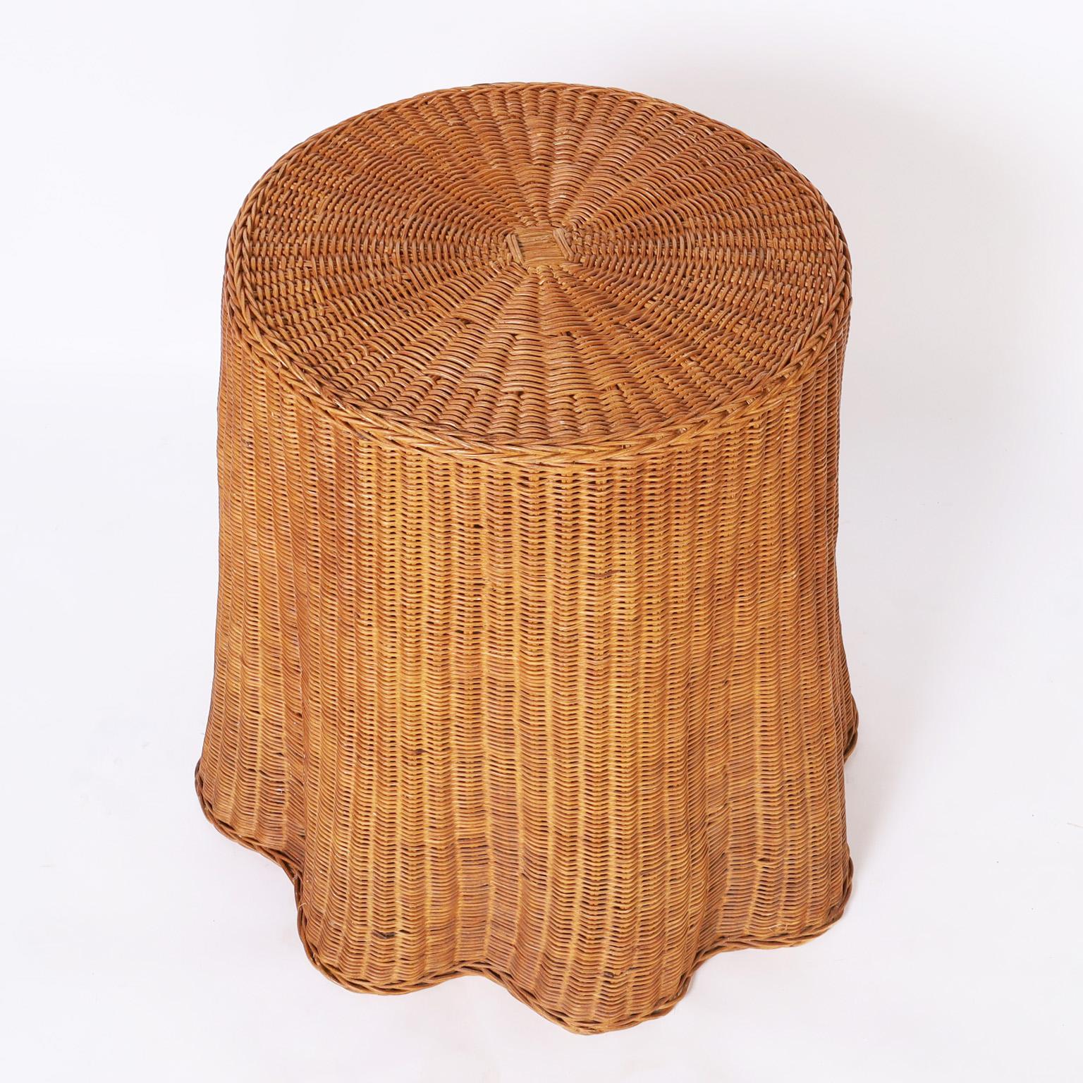 Vintage occasional table handcrafted in classic woven wicker in a ghost drapery form in its original organic patina.