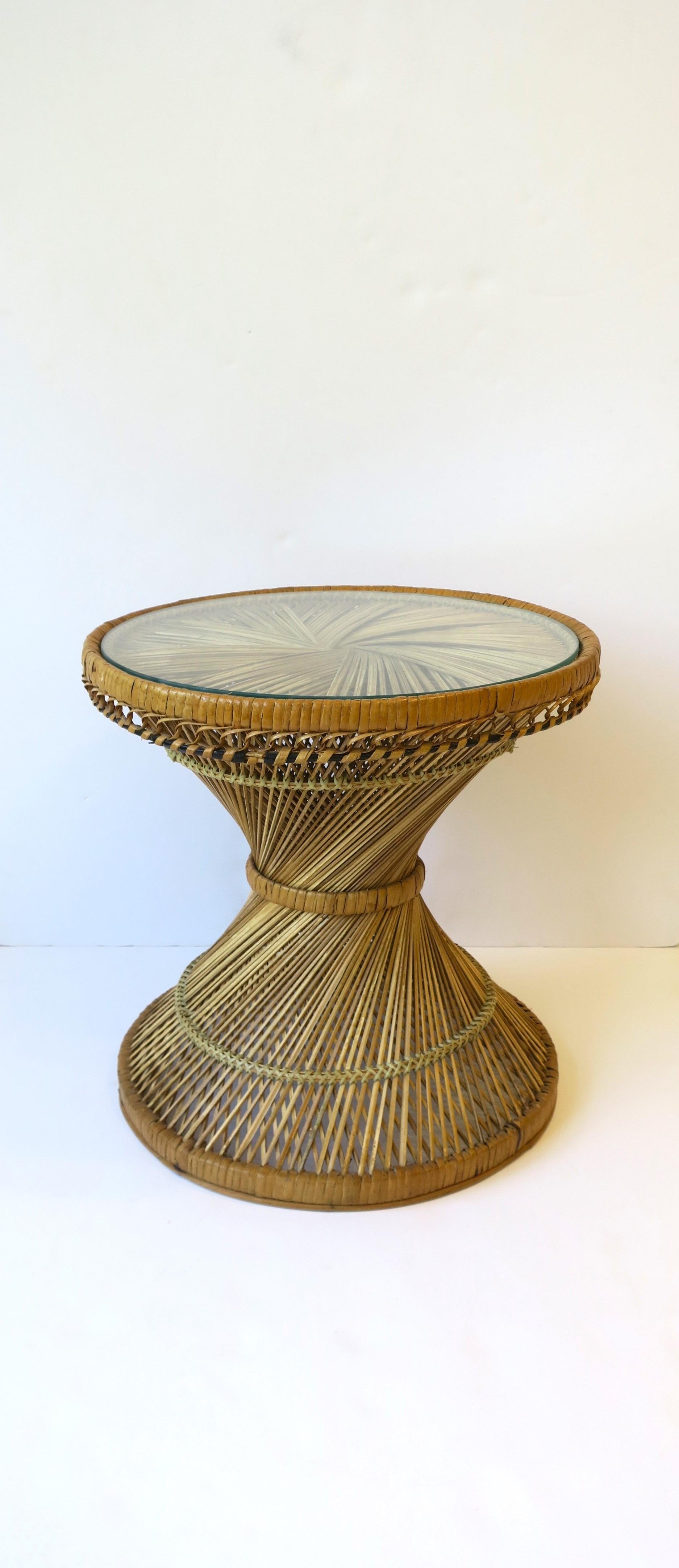 A beautiful and well-made wicker and glass round drinks or side table with hourglass design attributed to designer Emmanuelle Peacock, Bohemian design, circa mid-20th century, Spain. Very good condition as shown in images. Table is a convenient