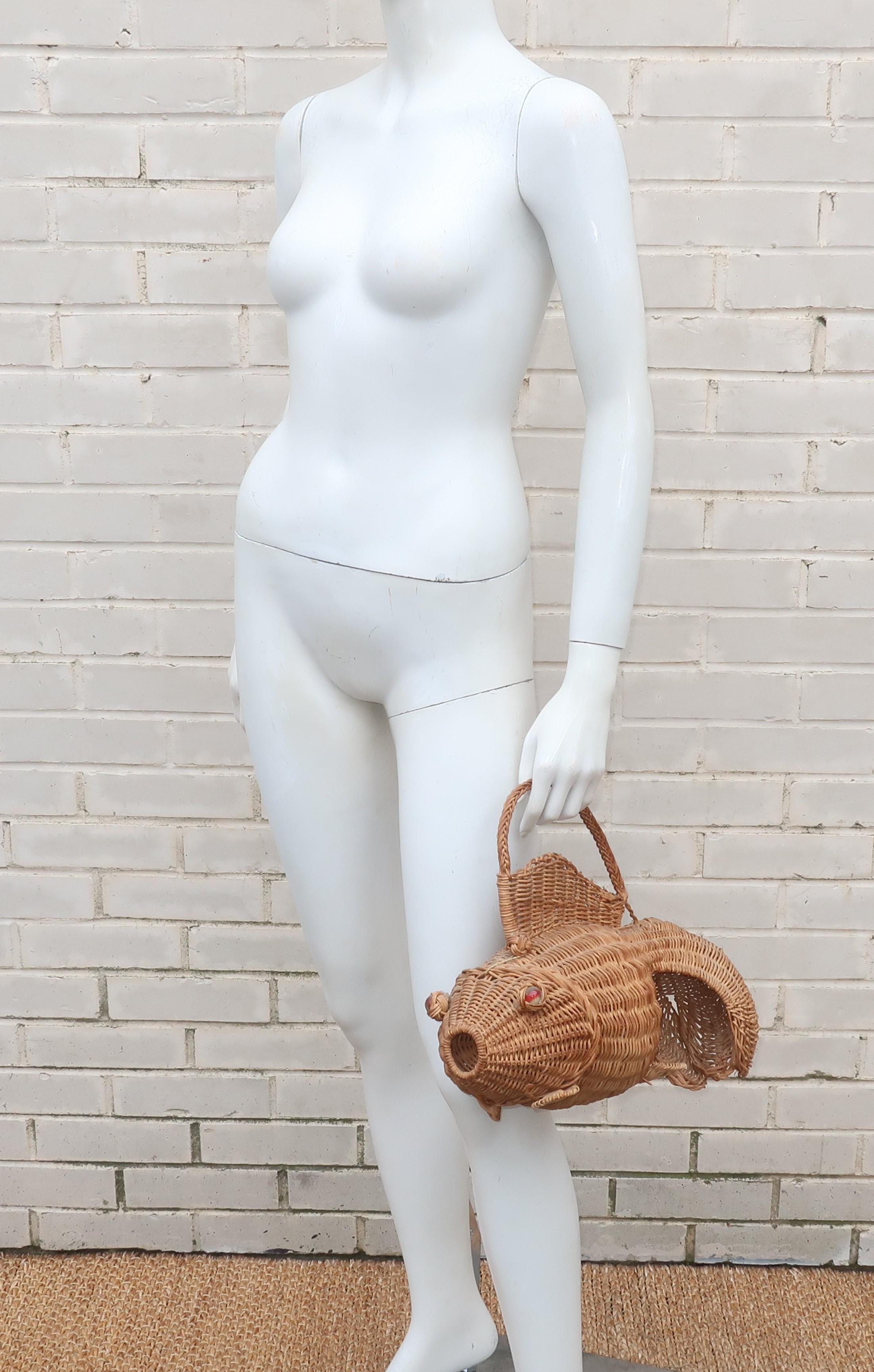 Personality plus!  This 1950's novelty goldfish wicker handbag is a great conversation piece and perfect to pair with sundresses and straw hats.  His top fin functions as a handle and he opens at the back of the head with a frog style closure to