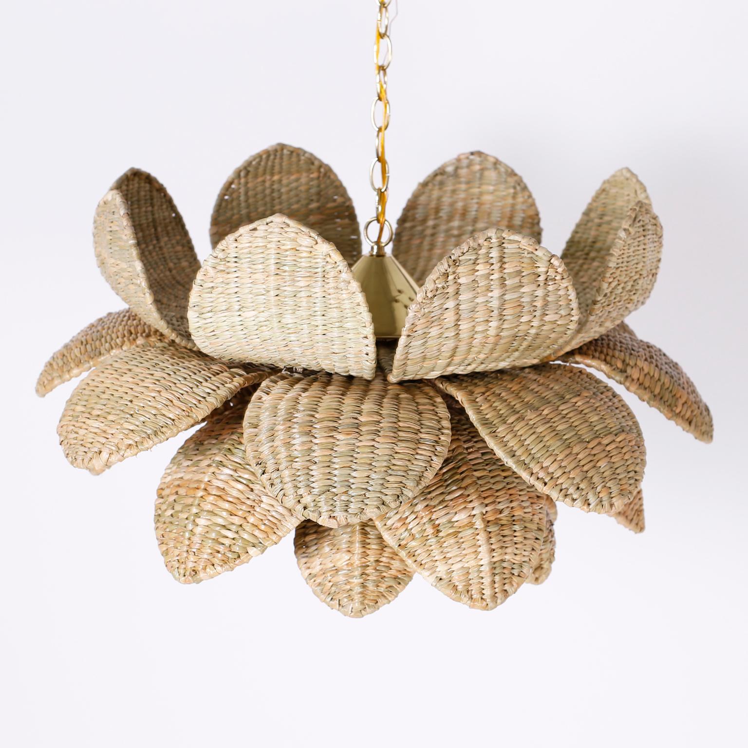 Wicker light fixture with an alluring lotus flower form crafted with a metal frame ambitiously wrapped in reed, in the manner of Mario Lopez Torres. Exclusively designed and offered by F. S. Henemader Antiques from the FS Flores Collection.
