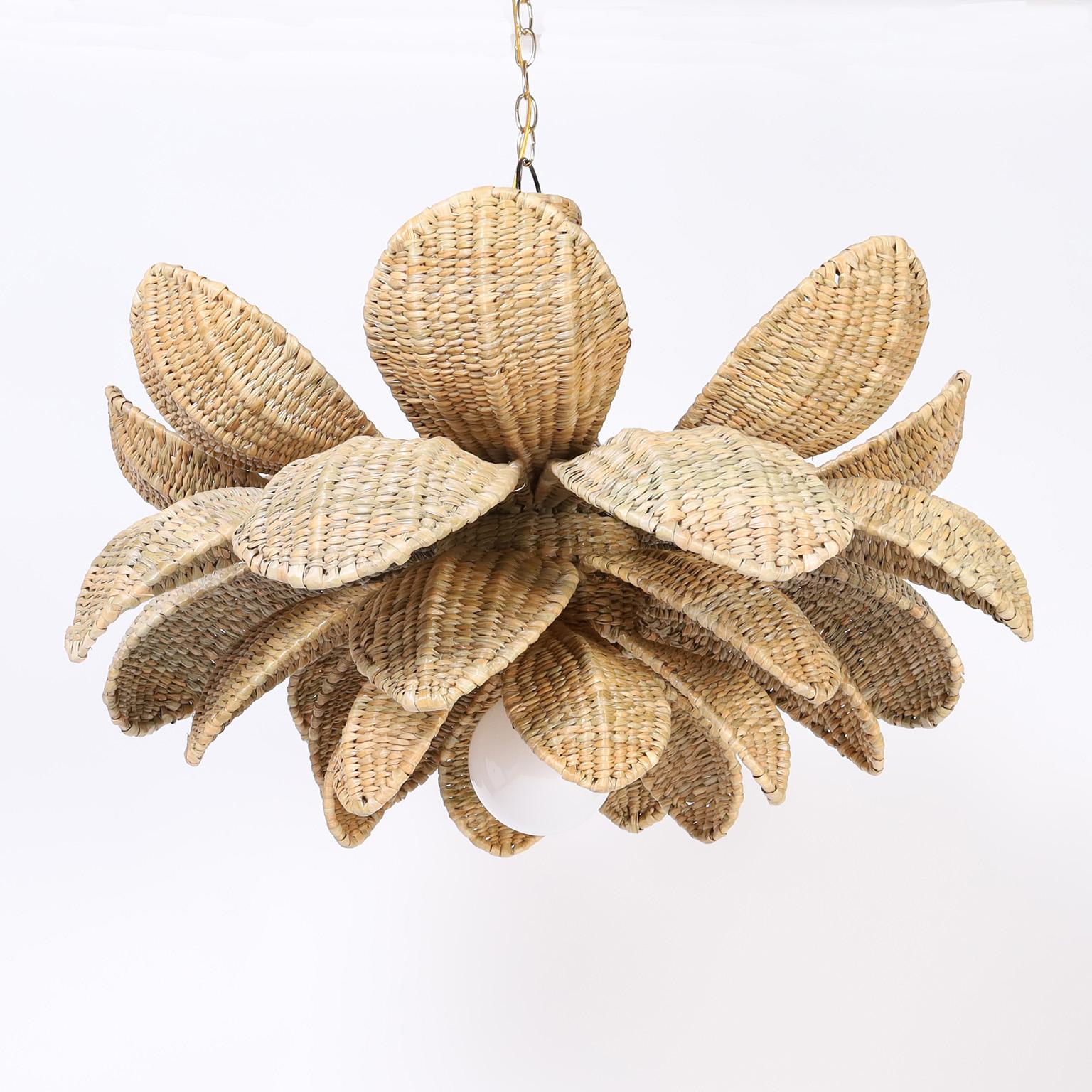 Chic wicker light fixture or pendant crafted with a sturdy metal frame ambitiously wrapped in reed in a four tiered lotus flower form, exclusively designed and offered by F. S. Henemader antiques as part of the FS Flores Collection.
