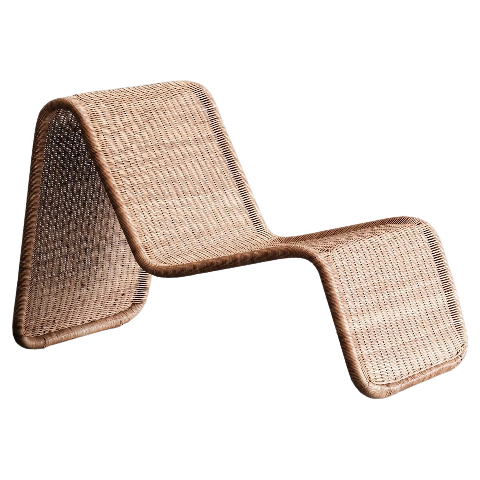 Wicker lounge chair in the manner of Tito Agnoli For Sale