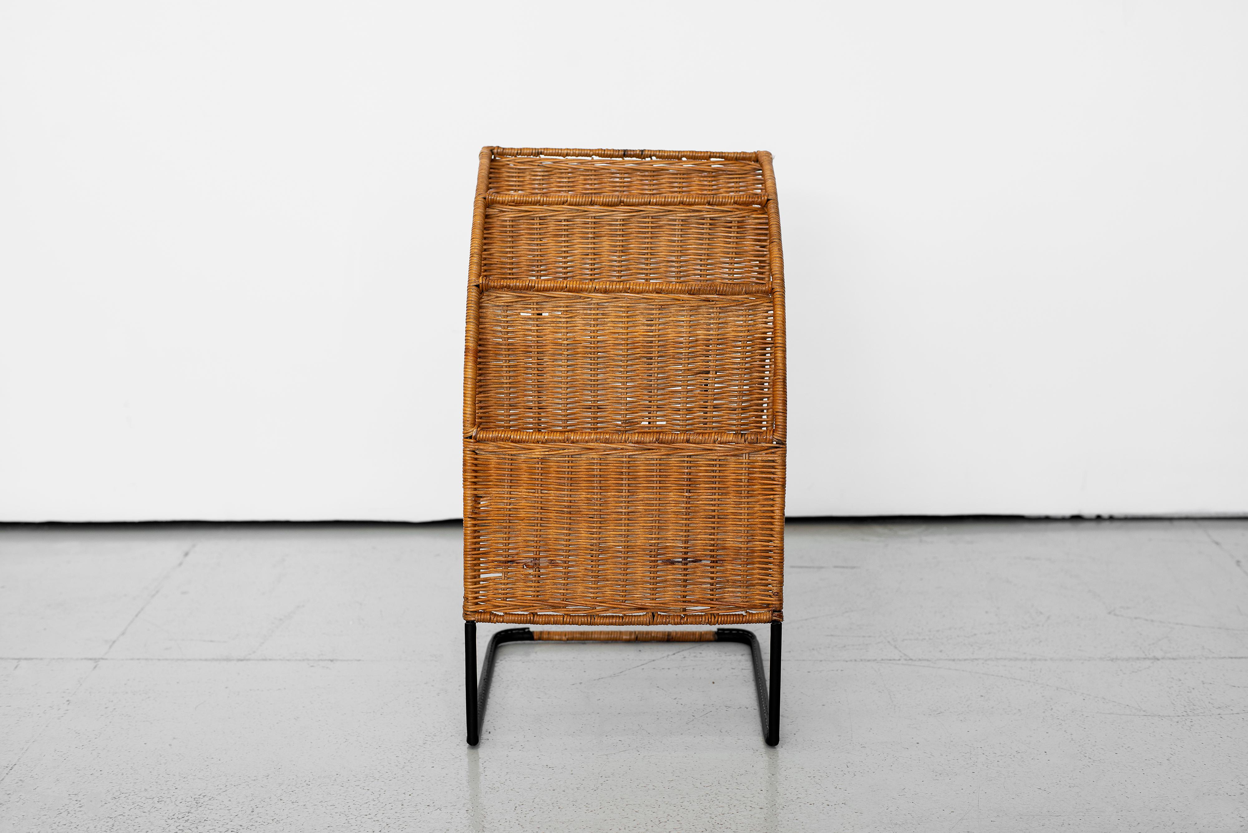 Unique French magazine rack attributed to Jacques Adnet. Multi-tier wicker rack with iron frame and newly wrapped black leather base.