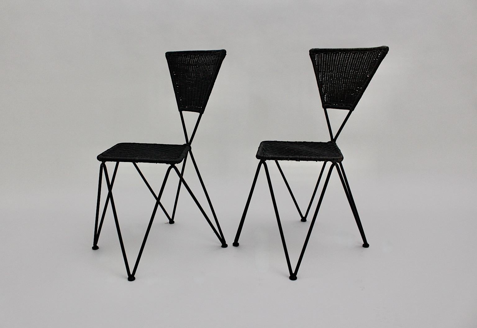 Wicker metal vintage dining chairs or patio chairs duo or pair of set of 2 designed by Karl Fostel Erben and executed by Sonett, Vienna, circa 1950.
The seat frame was made out of black lacquered iron, while the seat and back were dark blue
