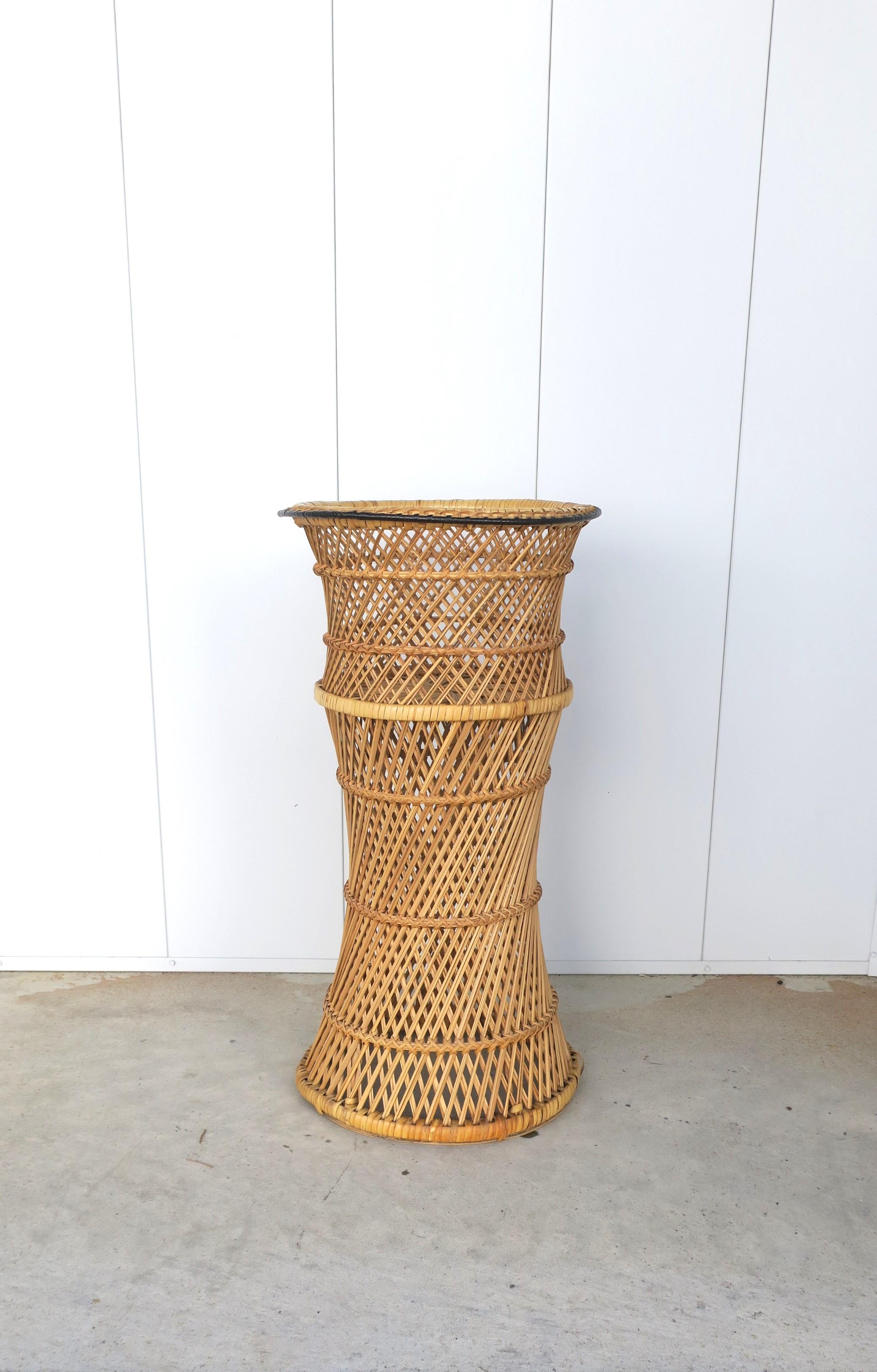 A tall wicker flower or plant cachepot jardiniere holder stand, circa mid to late-20th century. A great piece to elevate a flower or plant, indoors or outside covered patio. Piece is in the style of Emmanuelle Peacock. Dimensions include the