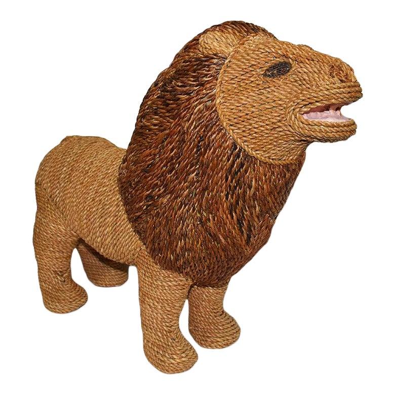 Large raffia or wicker woven animal figure of a Lion. This piece would make a lovely statement to any space. We especially love the idea of using this for a children's room or nursery. The Lion's body and tail are woven in a lighter raffia material,