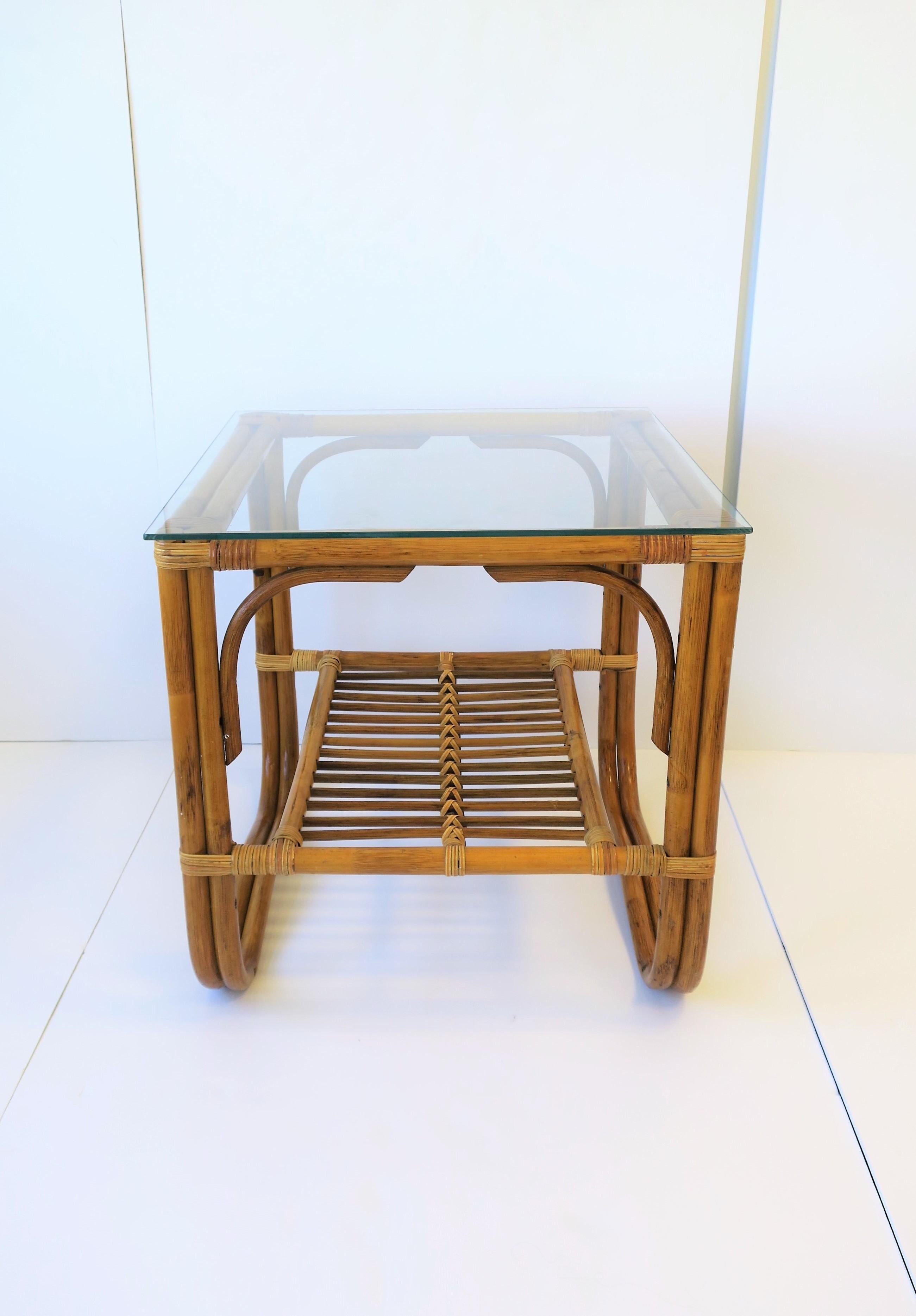 A vintage wicker rattan and glass square end table in the style of Franco Alabini, circa 20th century. Table has lower shelf that can hold books, magazines, etc. 

Table measures: 20