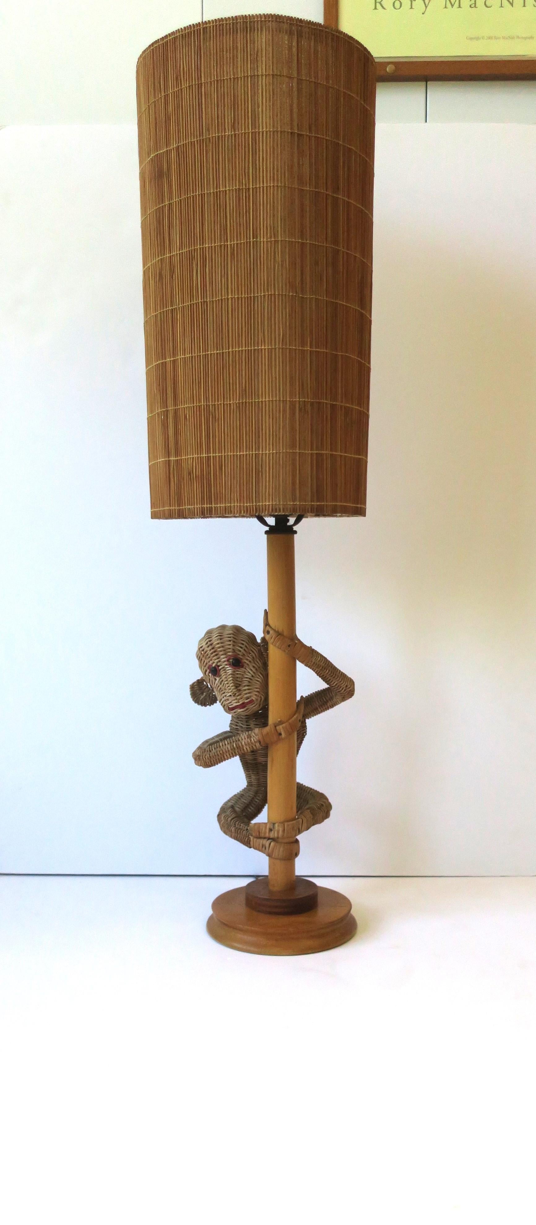 A wicker rattan monkey lamp with wicker shade, circa mid to late-20th century, late 1960s to early 1970s. Attributed to designer Mario Lopez Torres. Overall dimensions: 8