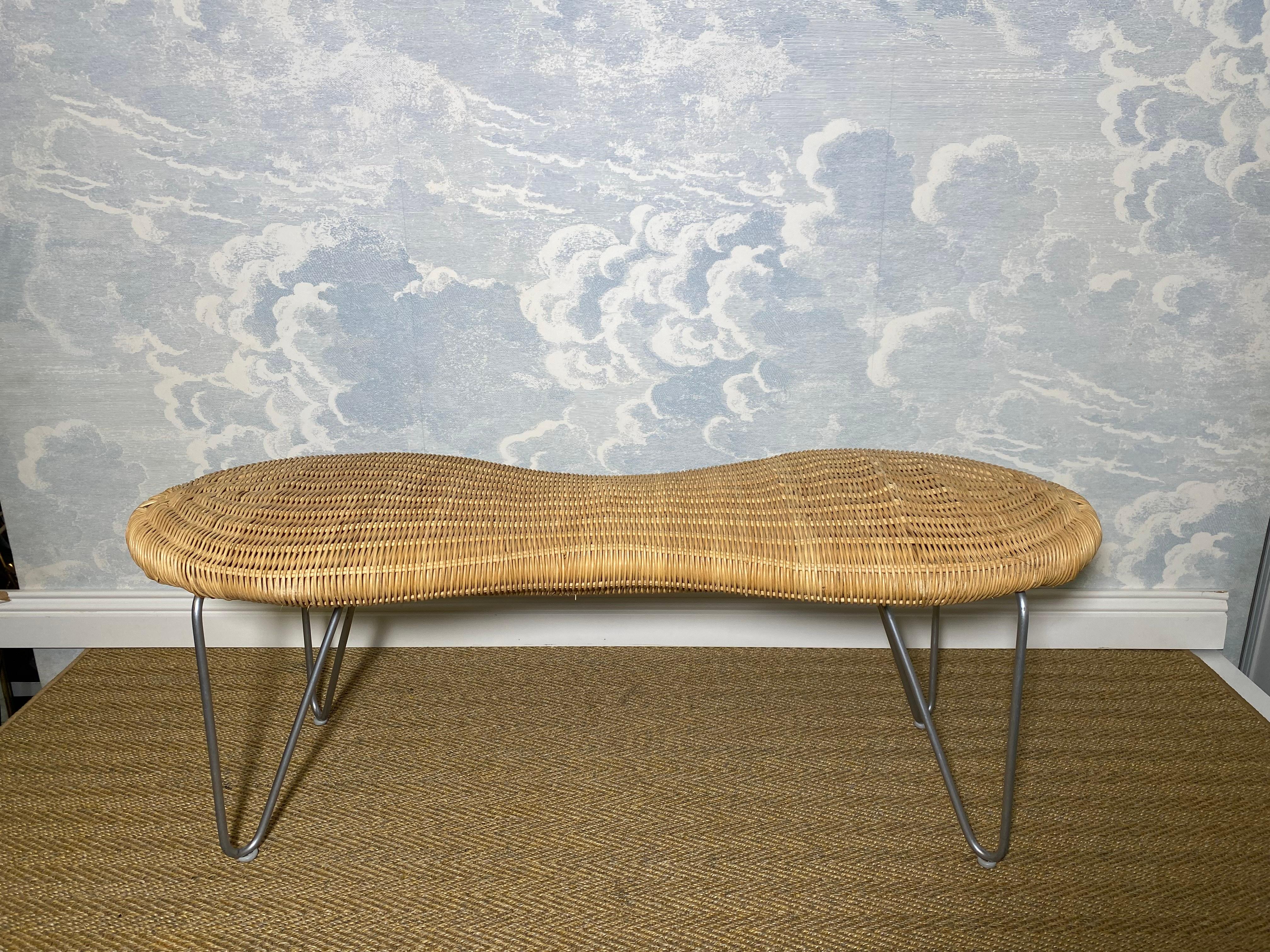 We discovered this charming wicker peanut-shaped bench in Southern Germany near Lake Konstanz and immediately fell in love with it. 

This organically shaped bench is in very good condition and made from rattan and wood. It sits on four hairpin legs