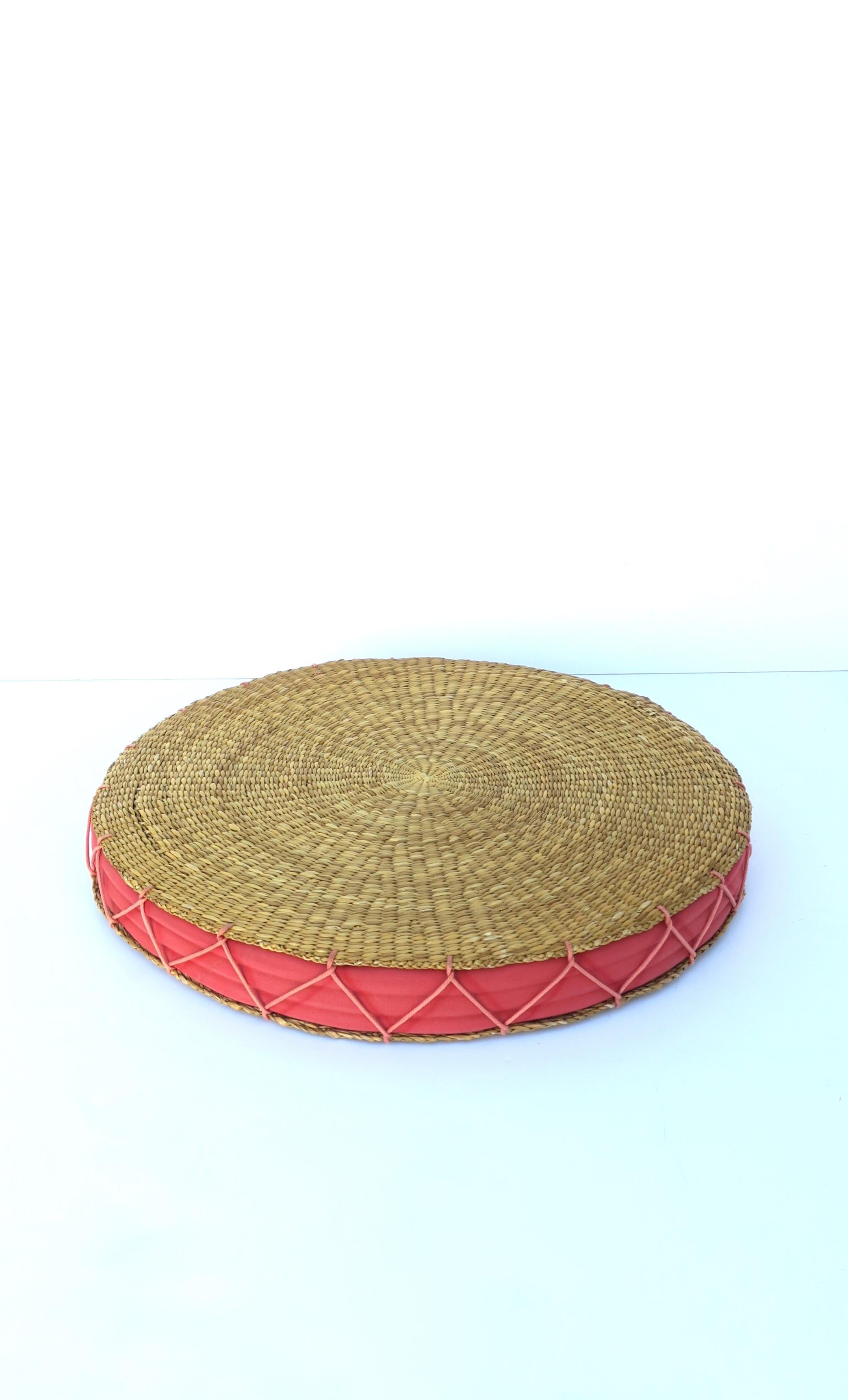 A vintage wicker and watermelon pink seat or floor cushion with cotton insert and large 'X' stitching around, circa mid to late-20th century. Piece could also be used as a tray to hold light items as demonstrated with coral piece. 

Dimensions: